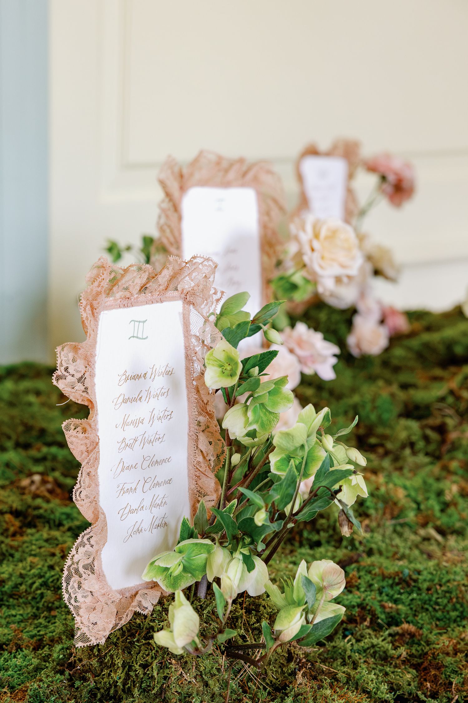 Romantic wedding seating chart surrounded by lush garden florals at Elkins Estate, a Philadelphia-area wedding venue.