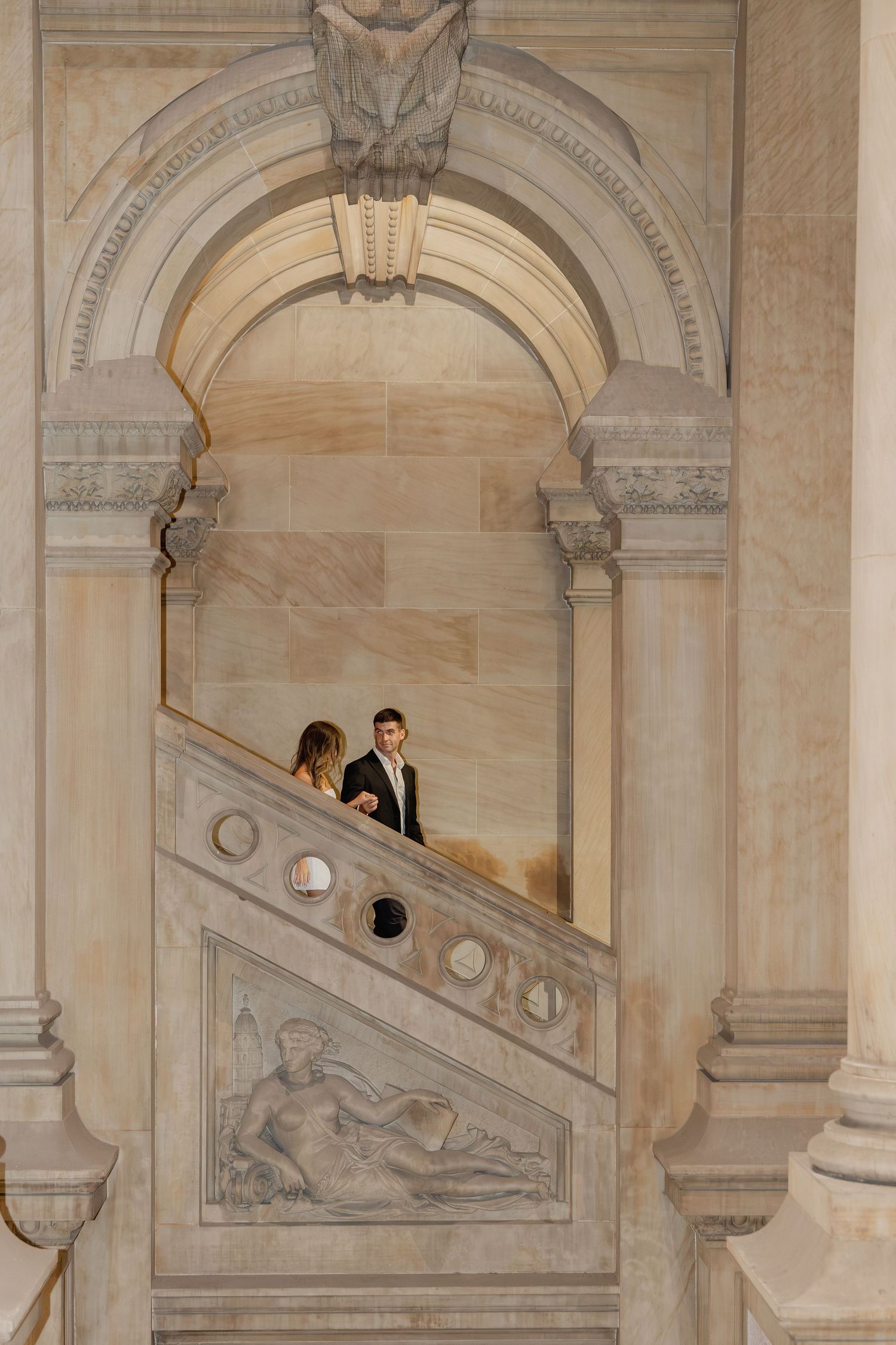 Couple photographed on the ornate stone staircase at Philadelphia City Hall during their classic Center City engagement session.