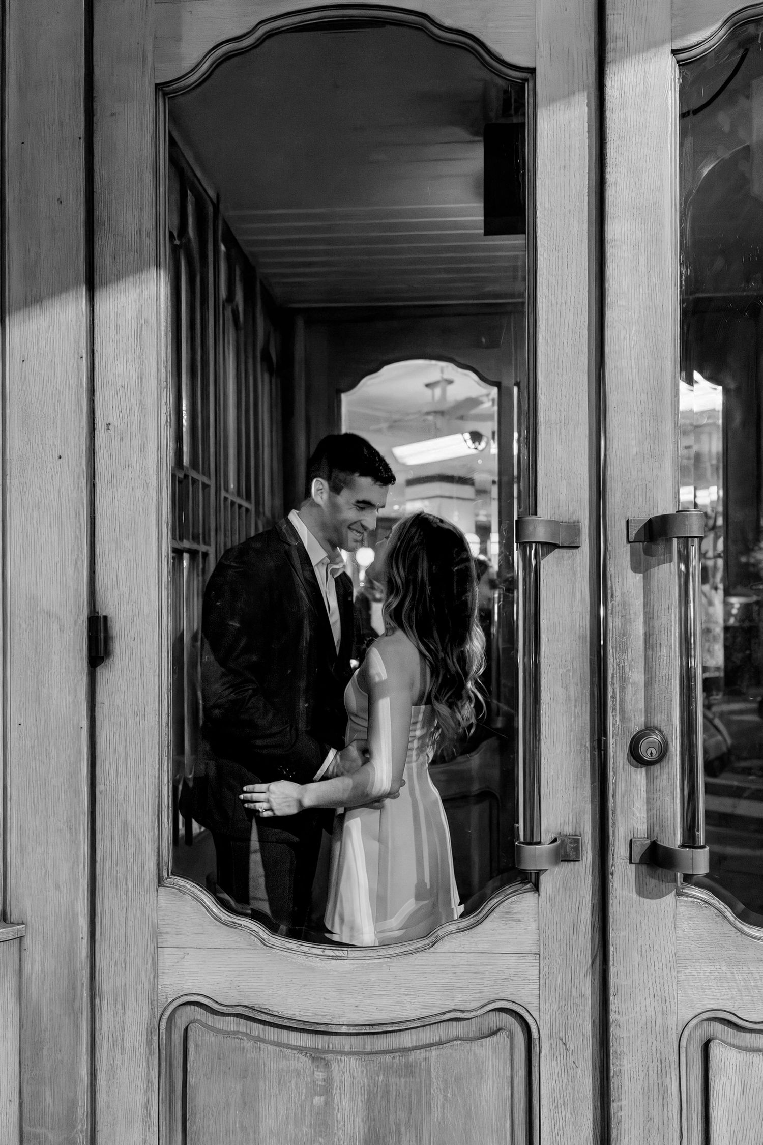Editorial Philadelphia engagement photo of a couple reflected in a mirror, featuring classic architectural details during their Center City