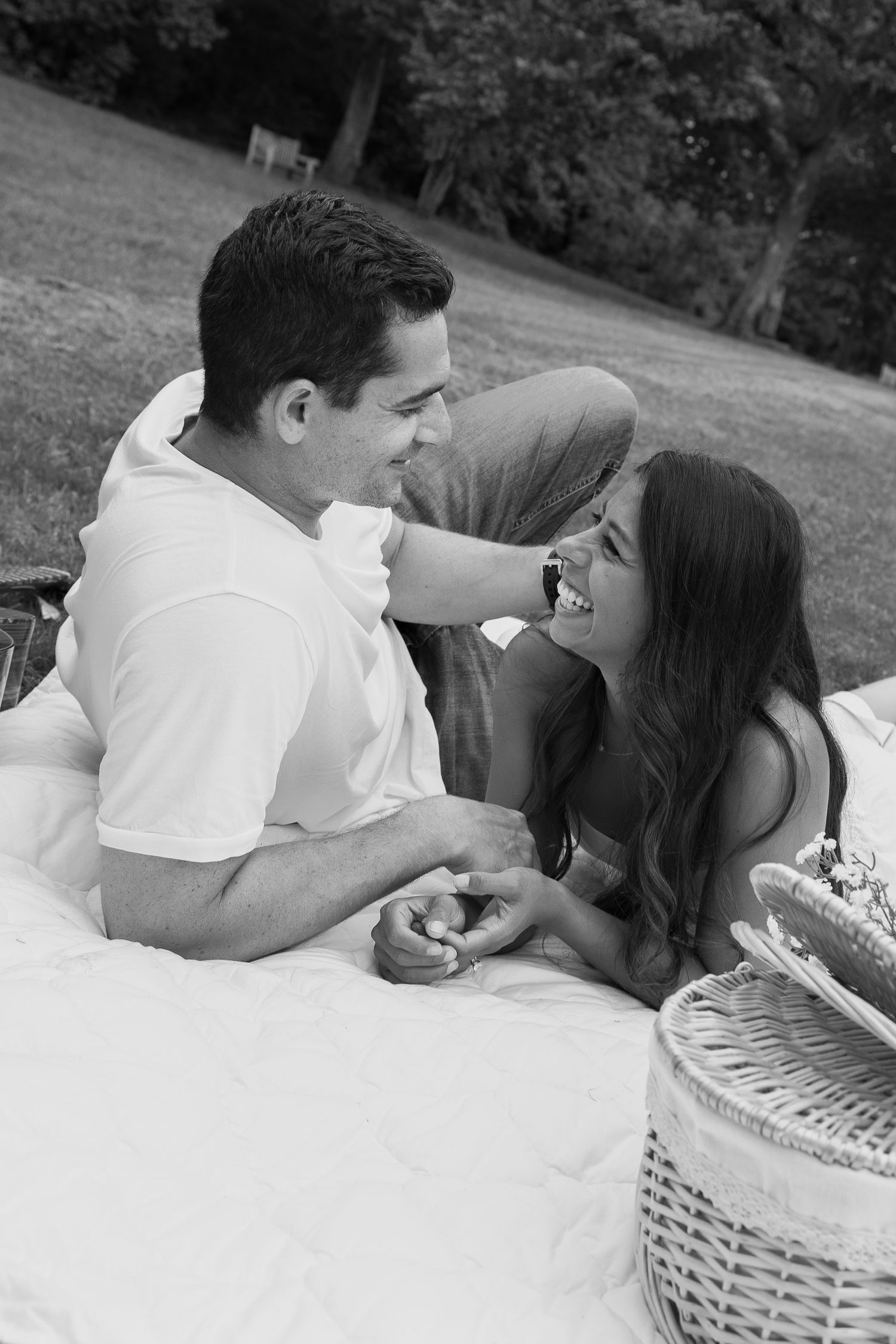 Black and white photo of a couple relaxing together during an outdoor picnic couples session in Pennsylvania