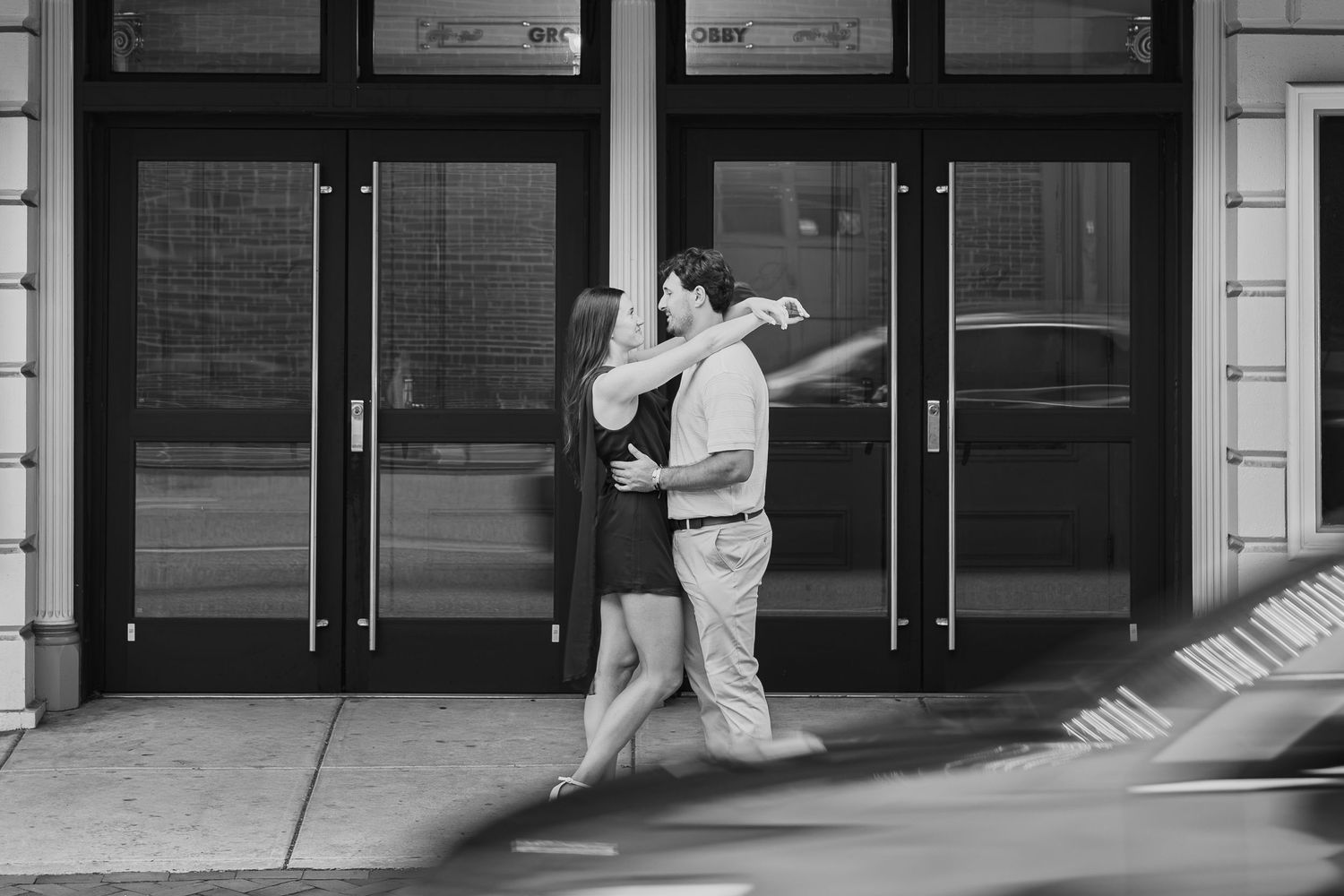 Engaged couple embracing in downtown Lancaster, Pennsylvania, photographed by Ashley Lynn Imagery.
