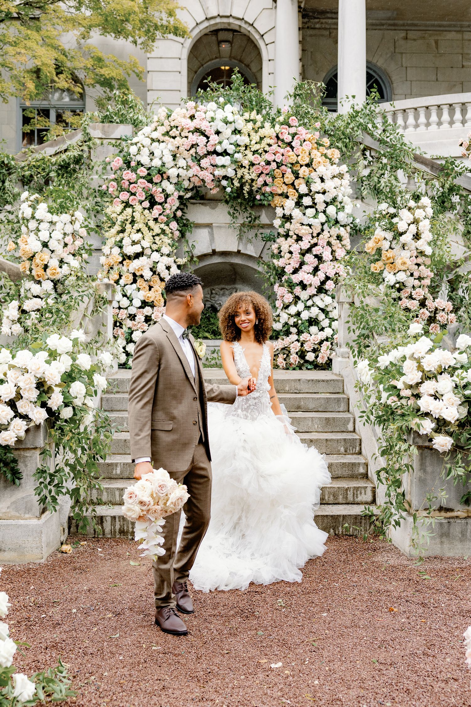 Bride and groom portrait surrounded by garden-inspired florals at the historic Elkins Estate wedding venue in Pennsylvania.