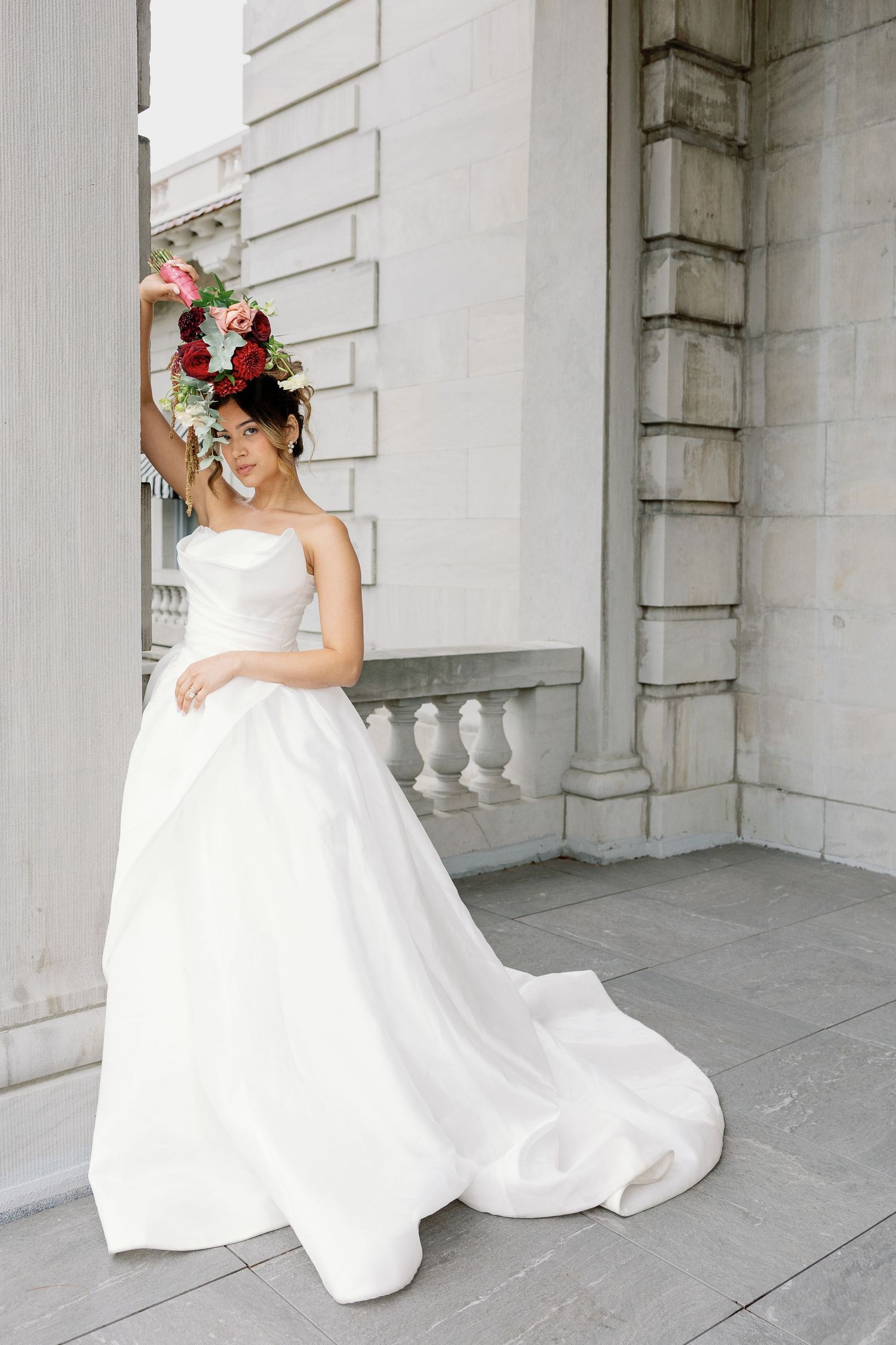 Bride in a lace wedding gown photographed at Elkins Estate in Elkins Park, Pennsylvania, surrounded by the historic architecture of Elstowe