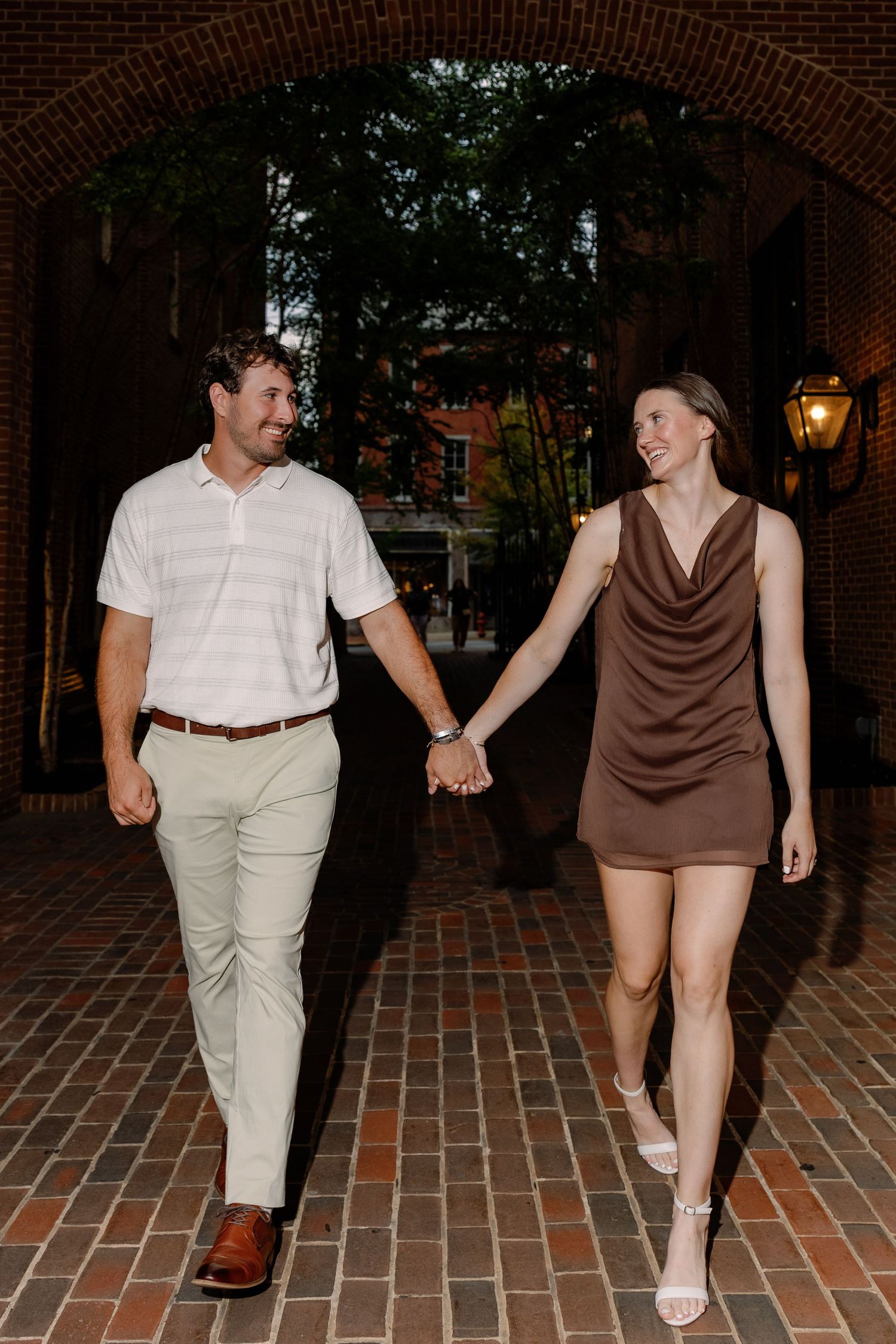 Couple walking hand in hand during a candid downtown Lancaster PA couples photography session