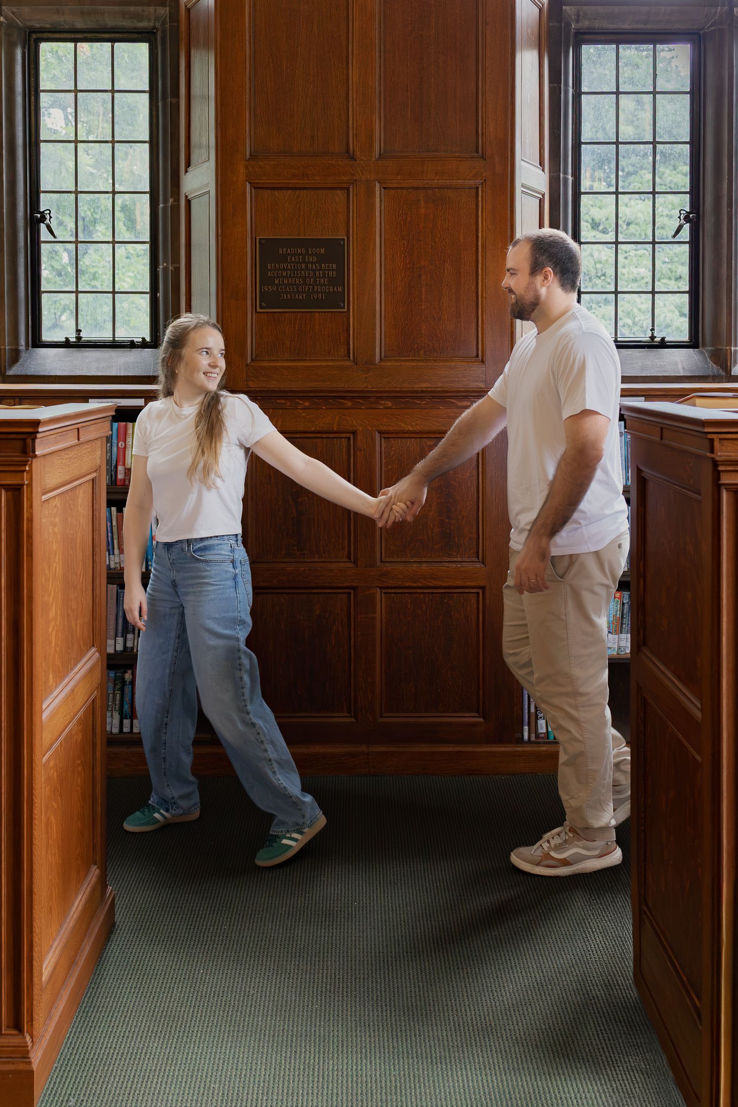 Couple holding hands inside historic Linderman Library at Lehigh University in Bethlehem, Pennsylvania.