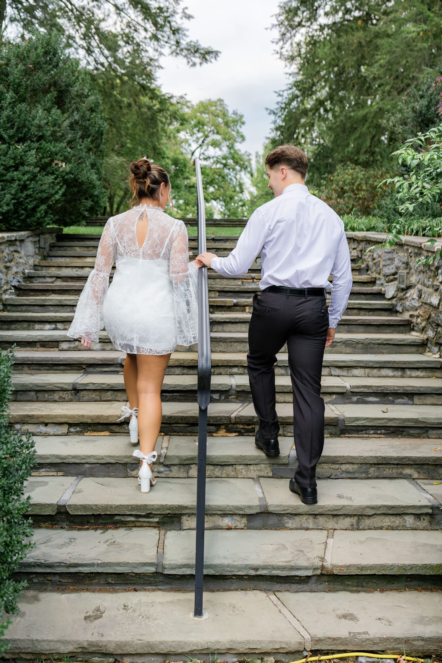 Engaged couple walking together down the garden steps at Conestoga House and Gardens in Lancaster, Pennsylvania.