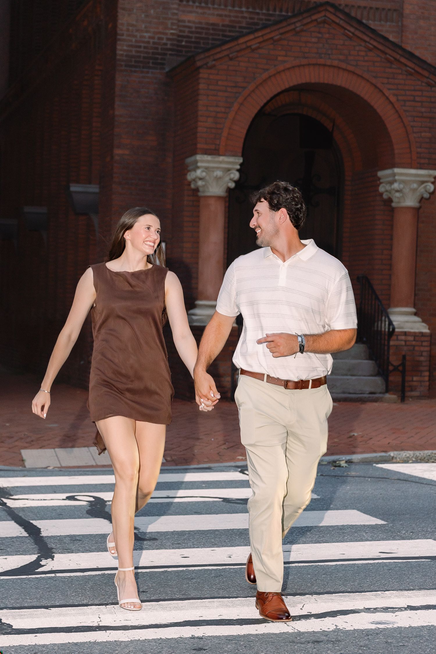 Engaged couple walking together through downtown Lancaster, Pennsylvania during their engagement photography session.