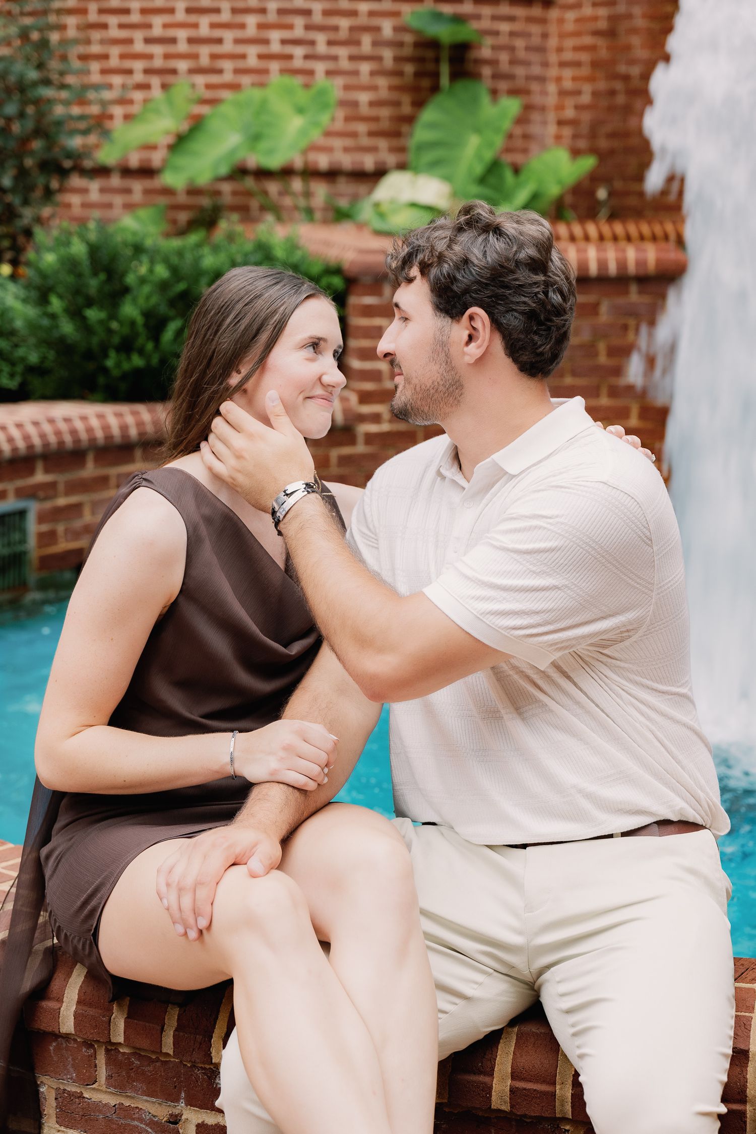 Engaged couple sitting together during a downtown Lancaster, Pennsylvania engagement photography session
