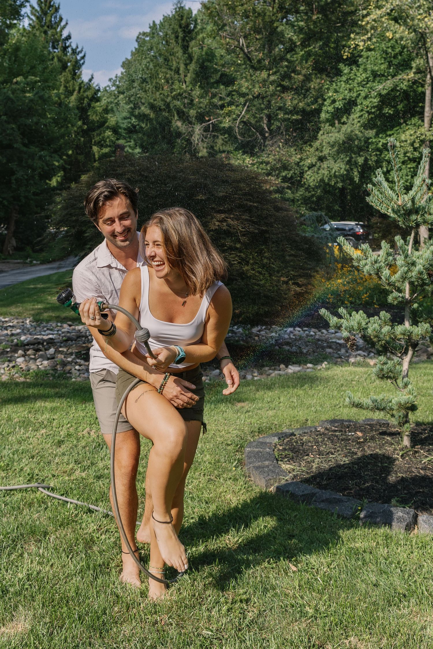 Couple laughing together during a playful summer couples photography session in Pennsylvania