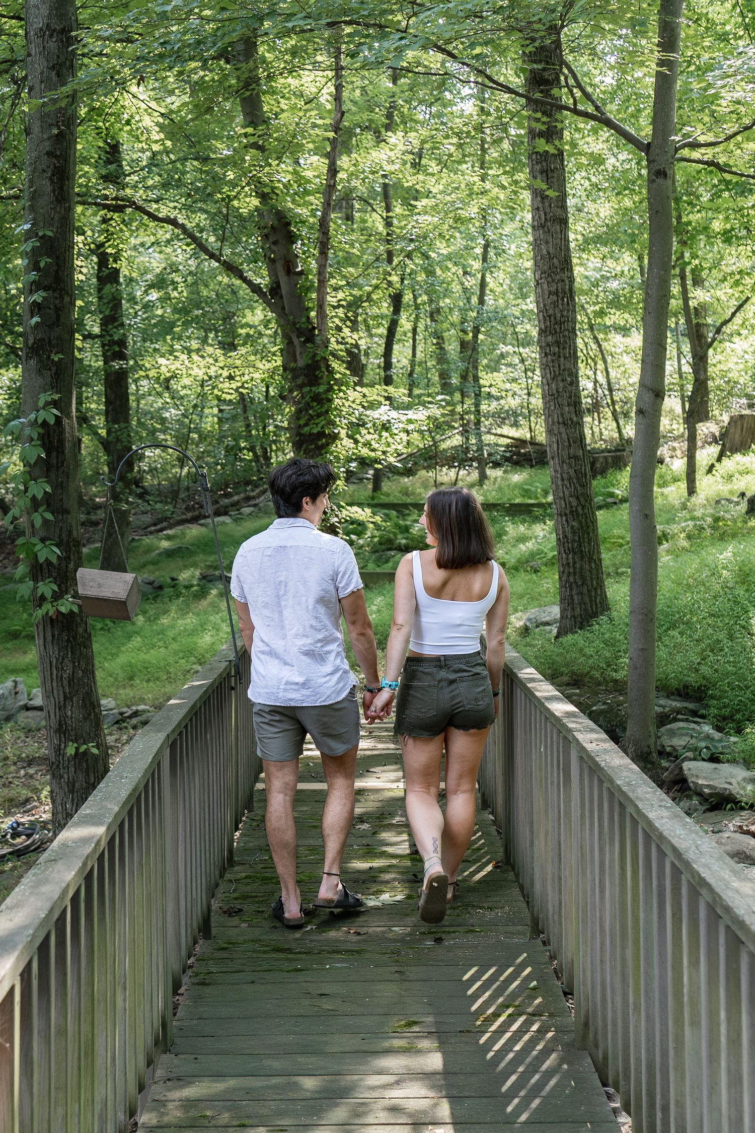 Couple walking together through a wooded setting during a candid Pennsylvania couples photography session