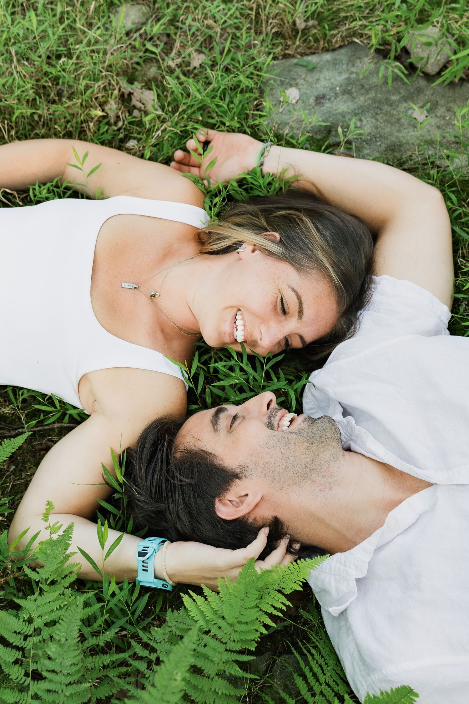 Couple lying together in the grass during a related Pennsylvania couples photography session.