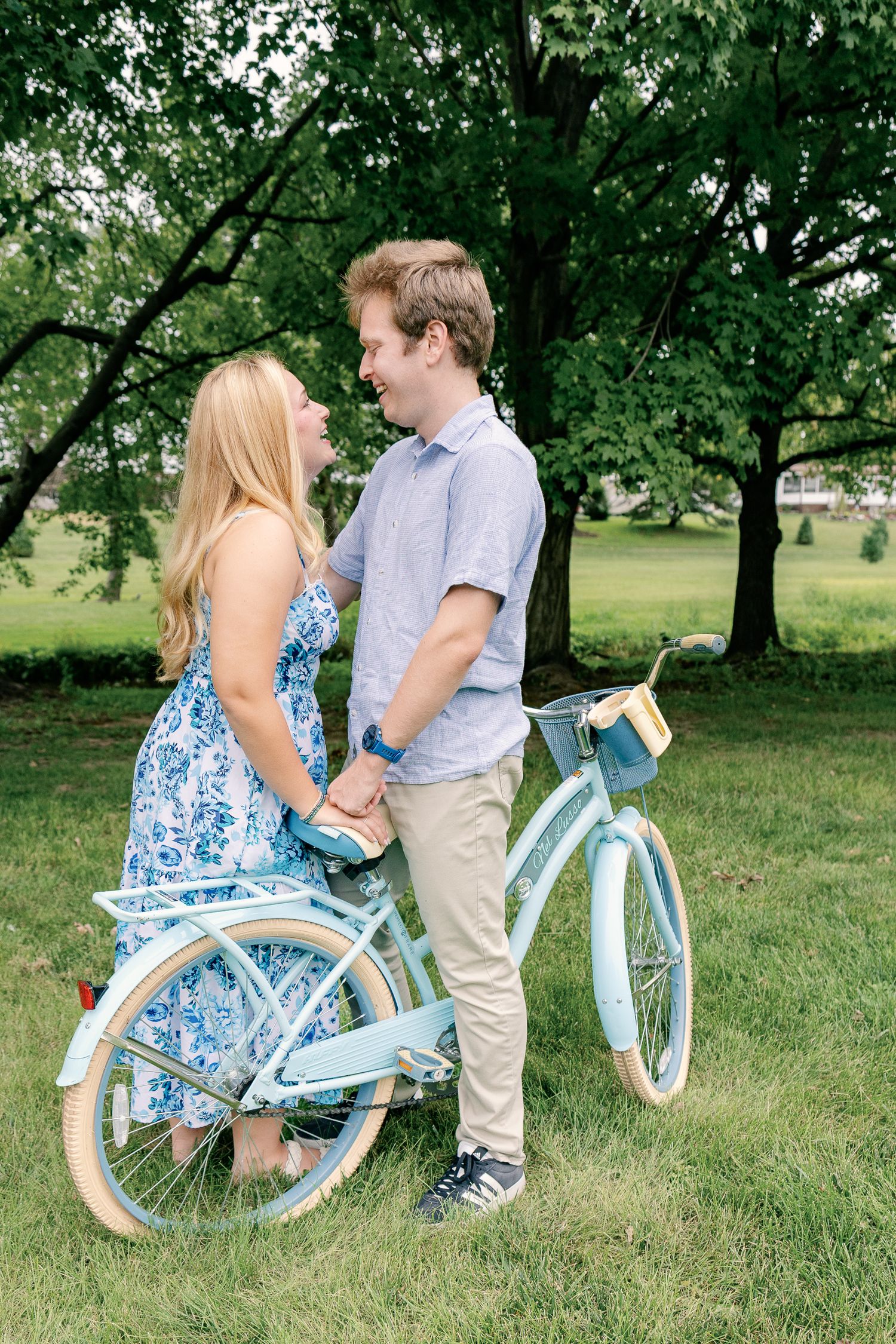 Couple standing together beside a vintage bicycle during an outdoor couples photography session at Greenfield Park in Lancaster, PA
