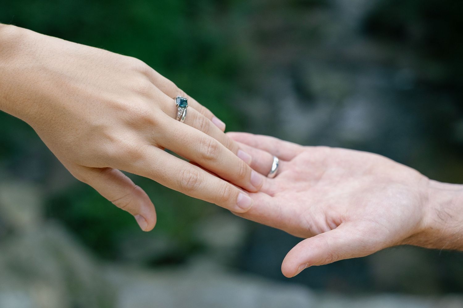Close-up of an engagement ring as a couple reaches for each other during a Pennsylvania engagement session.