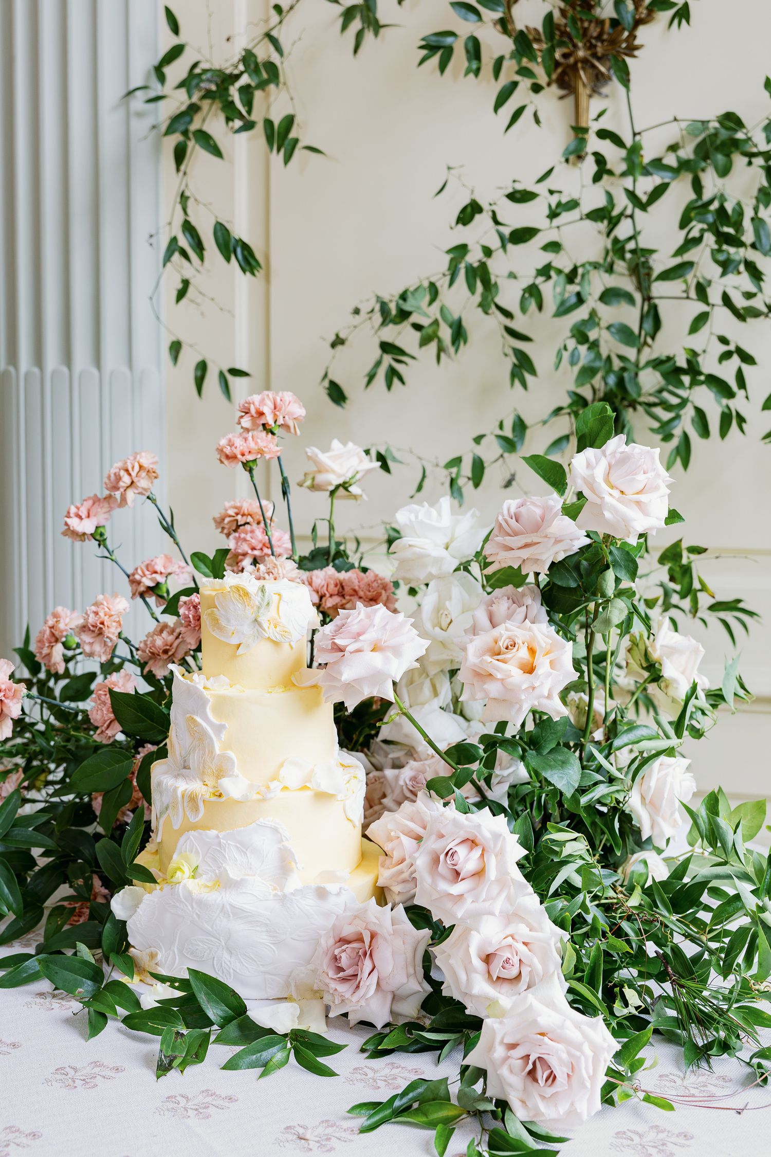Romantic wedding cake surrounded by lush pink and white florals at Elkins Estate, a historic Pennsylvania wedding venue.