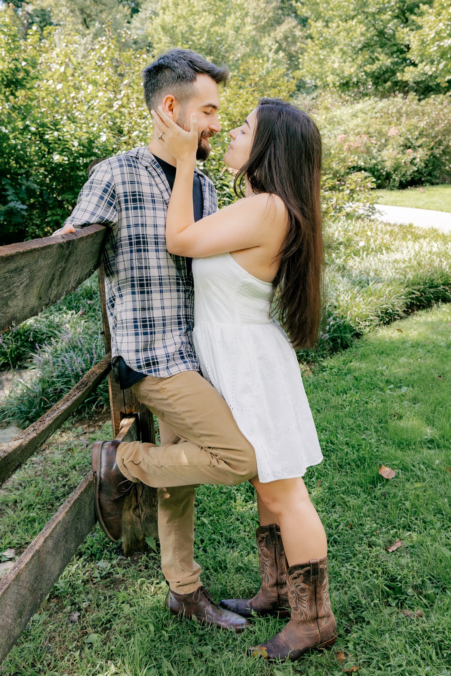 Couple sharing a romantic moment among the greenery during an outdoor couples photography session in Pennsylvania at Wolfs Hollow Park