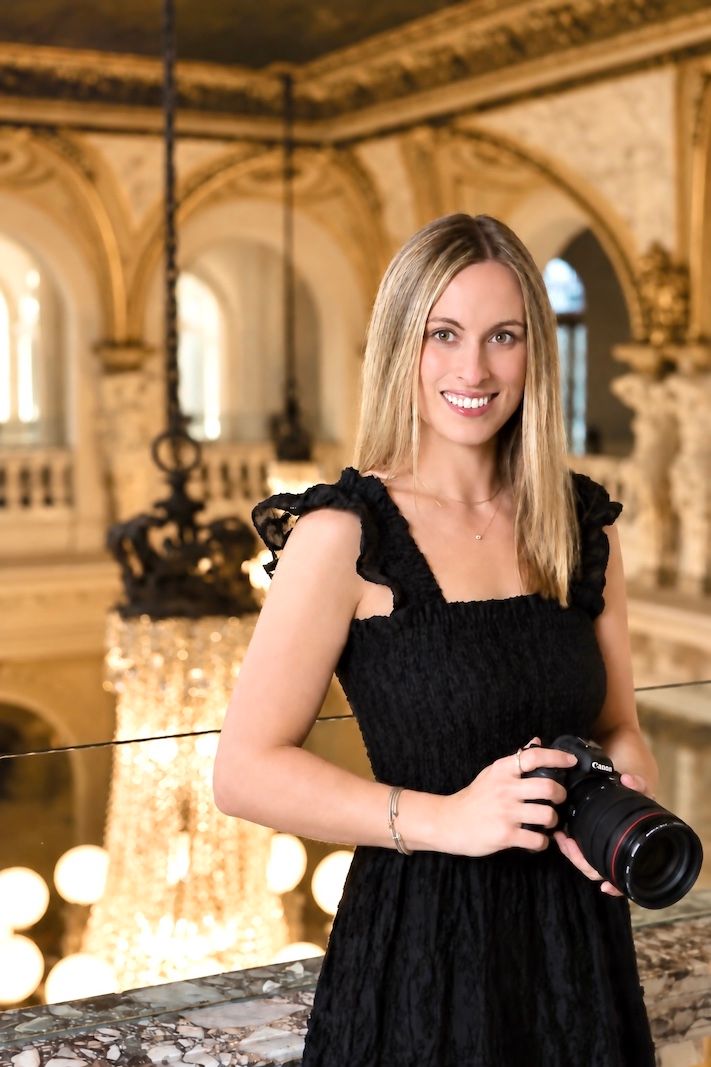 Ashley Lynn, Pennsylvania wedding and couples photographer posing with a camera at Elkins Estate wedding venue