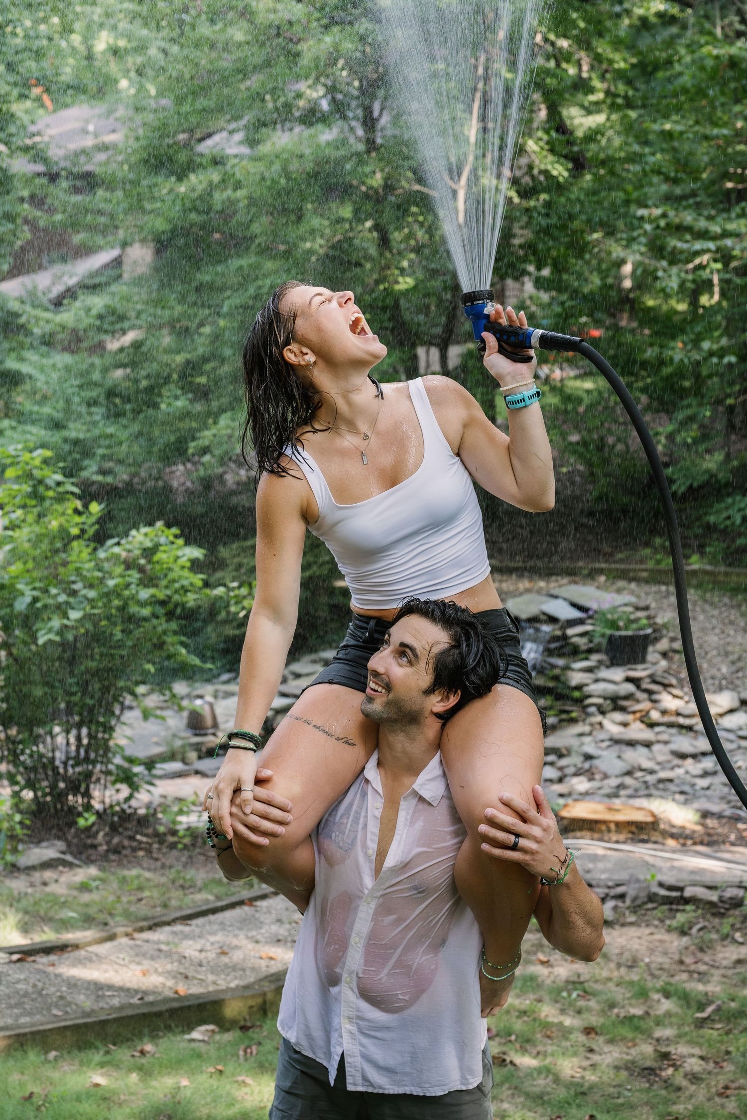 Couple laughing and playing together during a candid outdoor couples photography session in Pennsylvania
