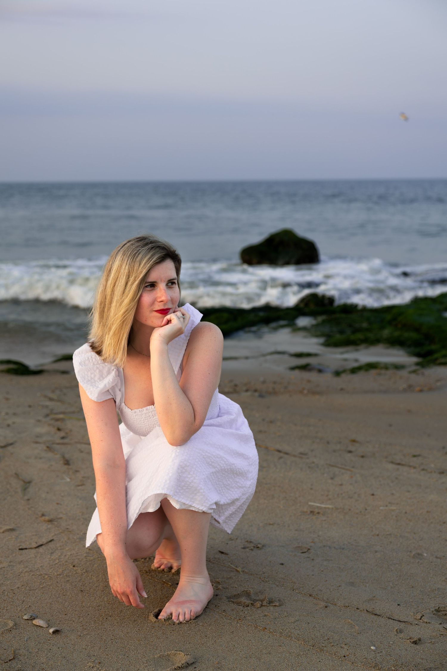 Couple embracing on the beach at sunset during a romantic couples photography session