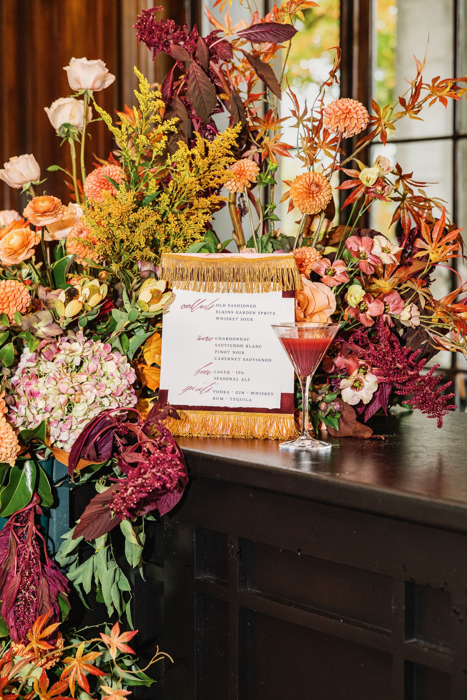 Elegant wedding stationery surrounded by rich florals at Elkins Estate, a historic wedding venue near Philadelphia.
