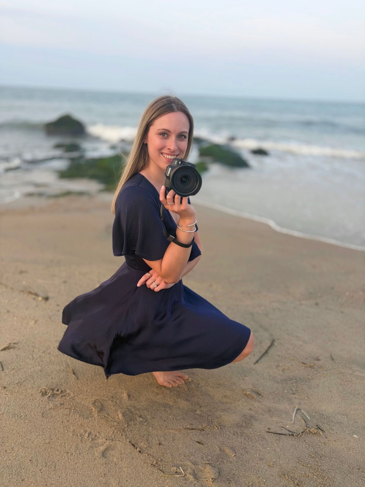 Woman sitting along the shoreline during a relaxed beach lifestyle portrait photography session
