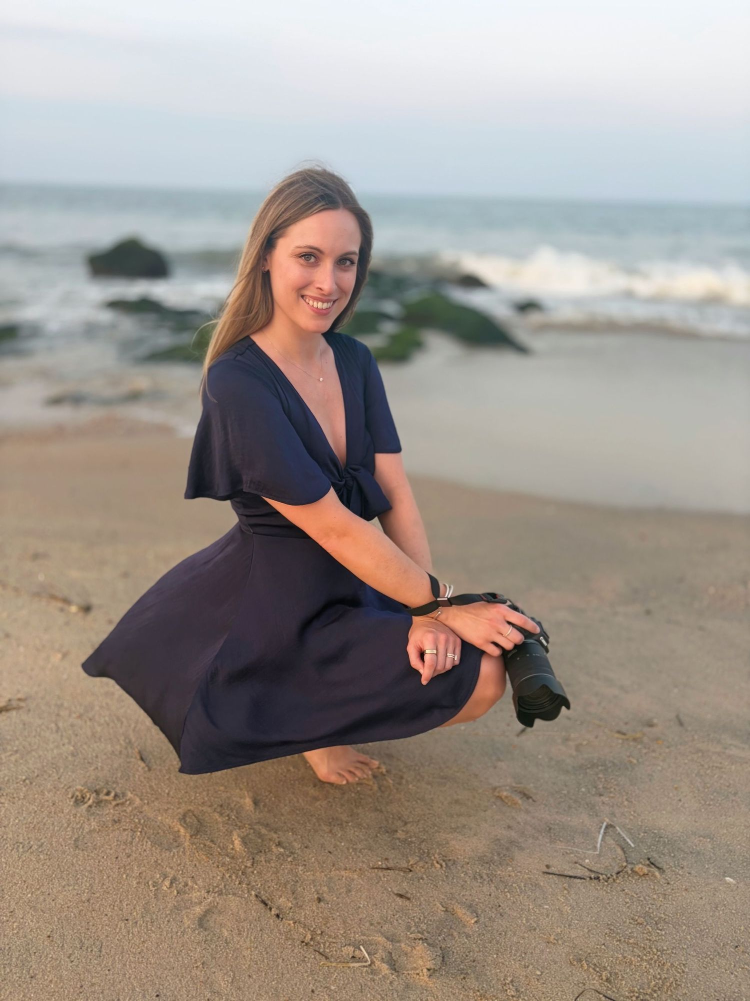 Woman sitting by the ocean during a relaxed beach lifestyle portrait photography session