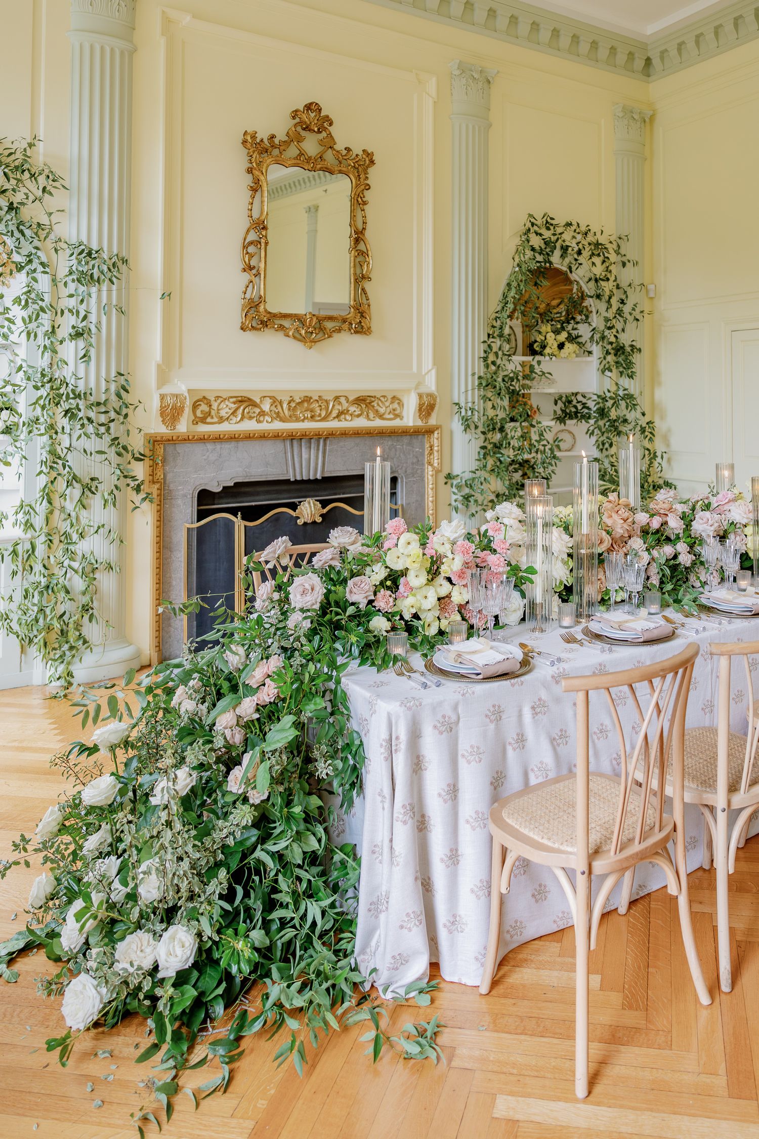 Elegant reception table with lush floral arrangements inside Elkins Estate, a historic Philadelphia-area wedding venue.