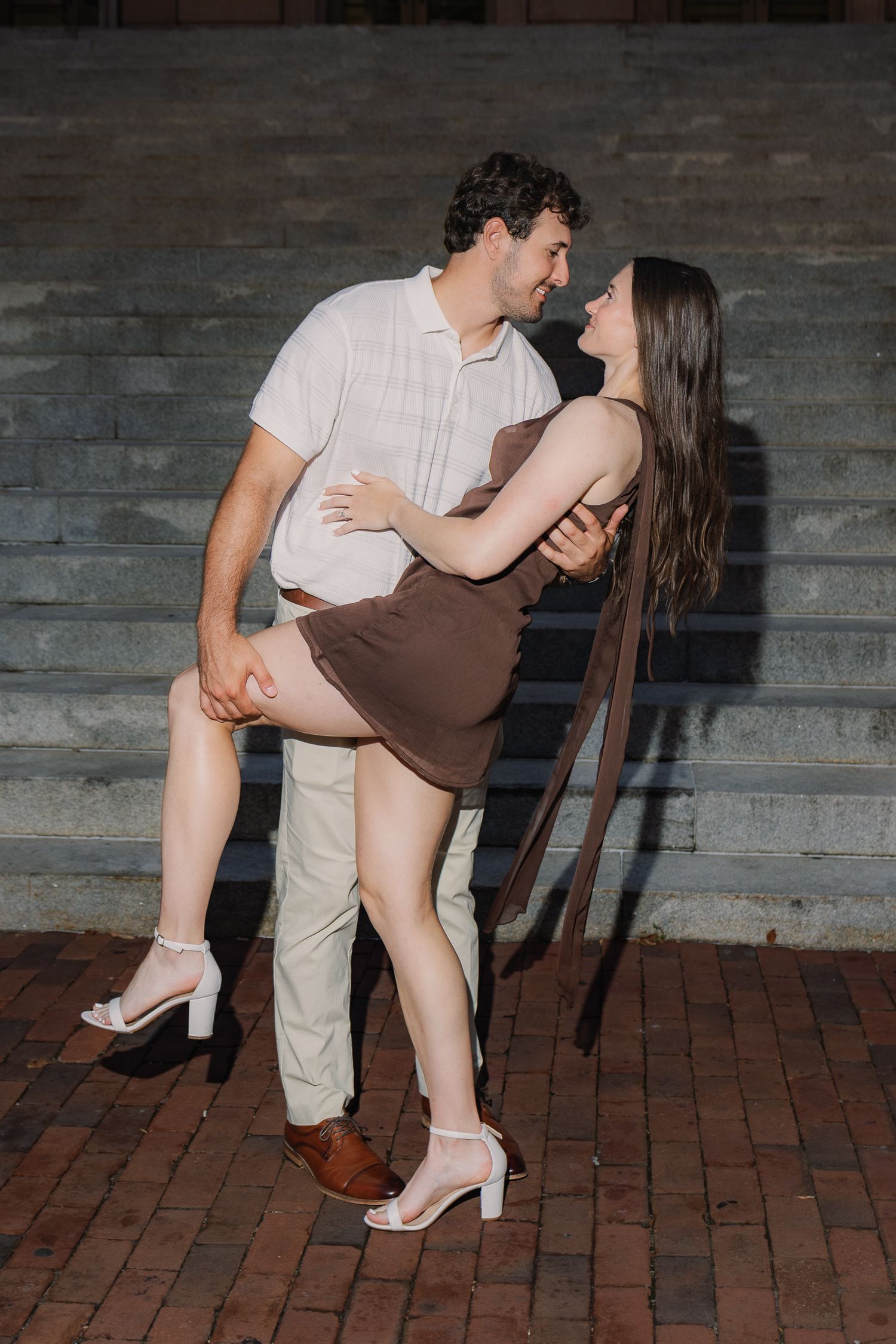 Engaged couple sharing a playful dip during their downtown Lancaster, Pennsylvania engagement photography session