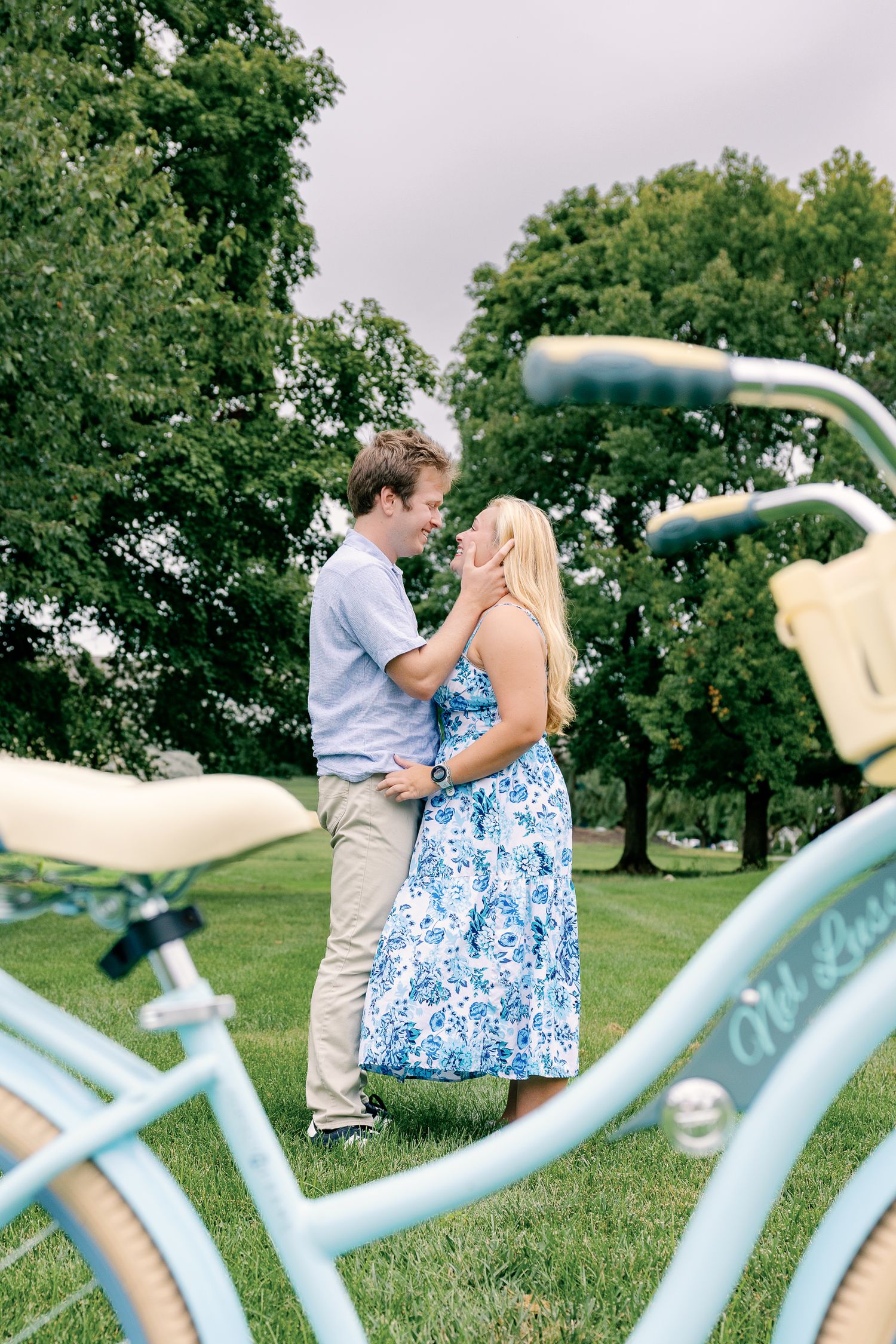 Couple embracing behind a vintage bicycle during a Greenfield Park couples photography session in Lancaster, Pennsylvania.