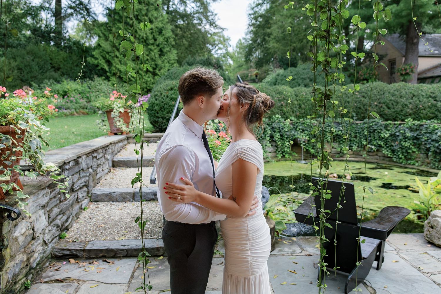 Engaged couple sharing a quiet moment together in the gardens at Conestoga House and Gardens in Lancaster, Pennsylvania.