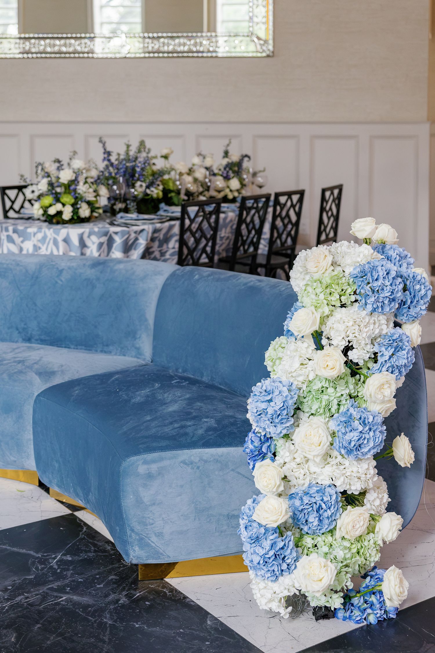 Blue wedding reception table with cascading white and blue florals photographed at the historic Elkins Estate in Elkins Park, Pennsylvania.