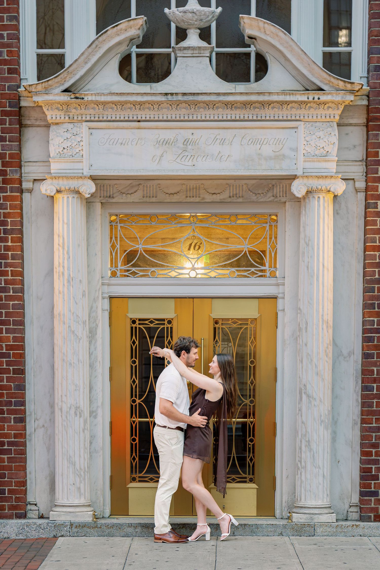 Couple standing together in a historic doorway during a downtown Lancaster Pennsylvania couples photography session