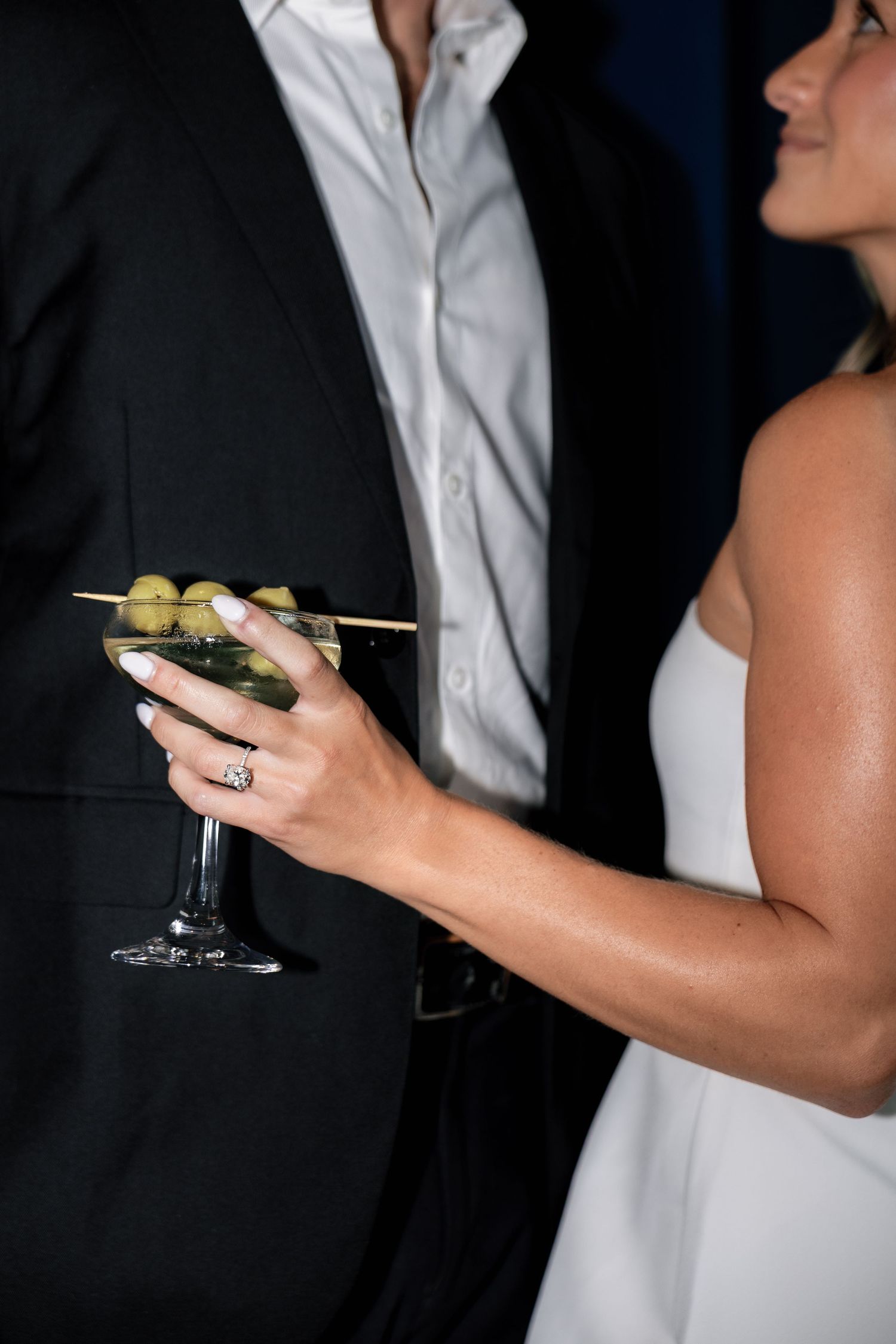 Close-up engagement photograph of a couple holding cocktails, capturing the details of their Philadelphia engagement session.