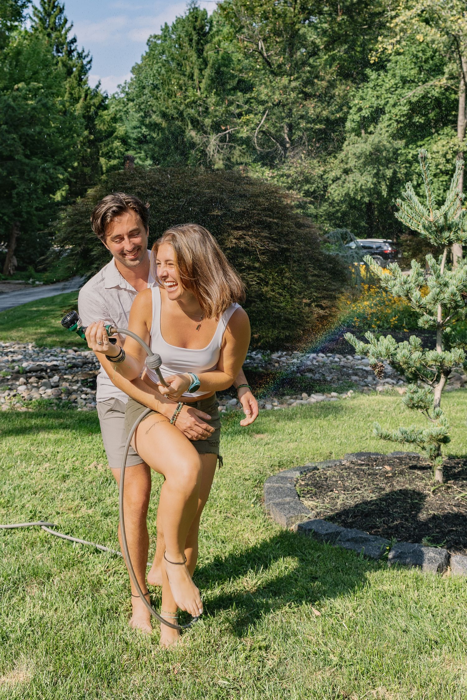 Couple running together through the grass during a playful Pennsylvania couples photography session