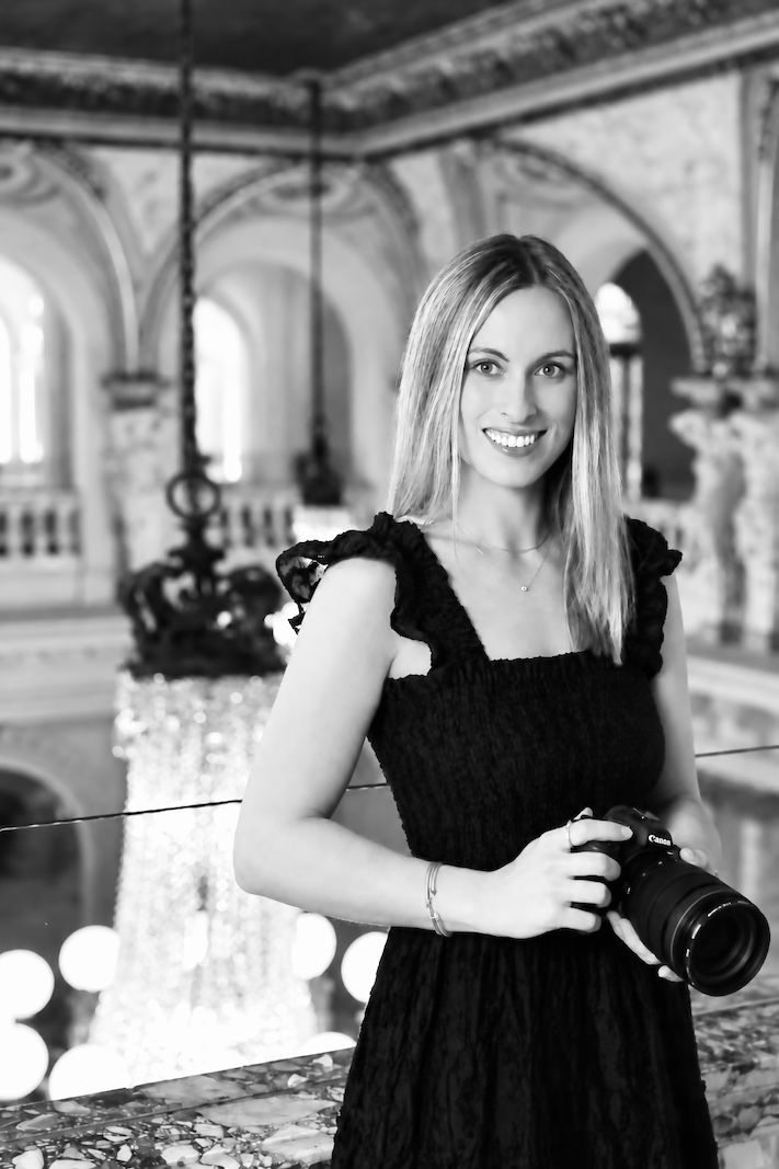Ashley Lynn, Pennsylvania wedding and couples photographer posing with a camera at Elkins Estate wedding venue