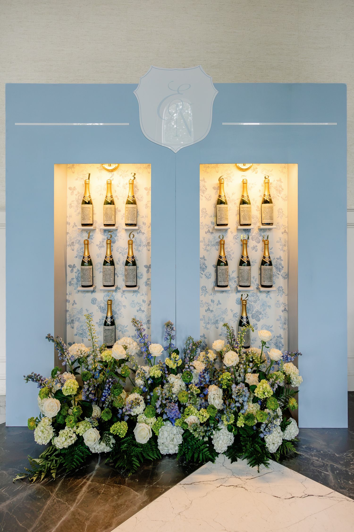 Lush floral arrangement beneath ornate windows inside Elkins Estate, a historic wedding venue in Elkins Park, Pennsylvania.