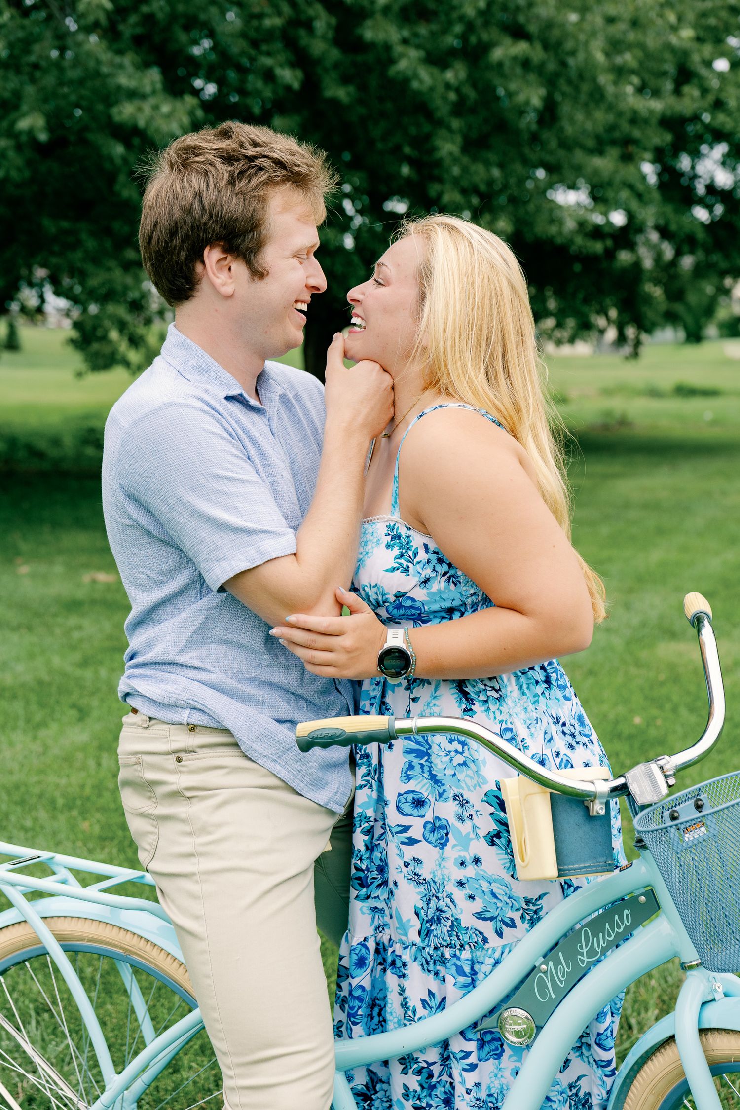Couple kissing beside a vintage bicycle during an outdoor couples photography session at Greenfield Park in Lancaster, Pennsylvania
