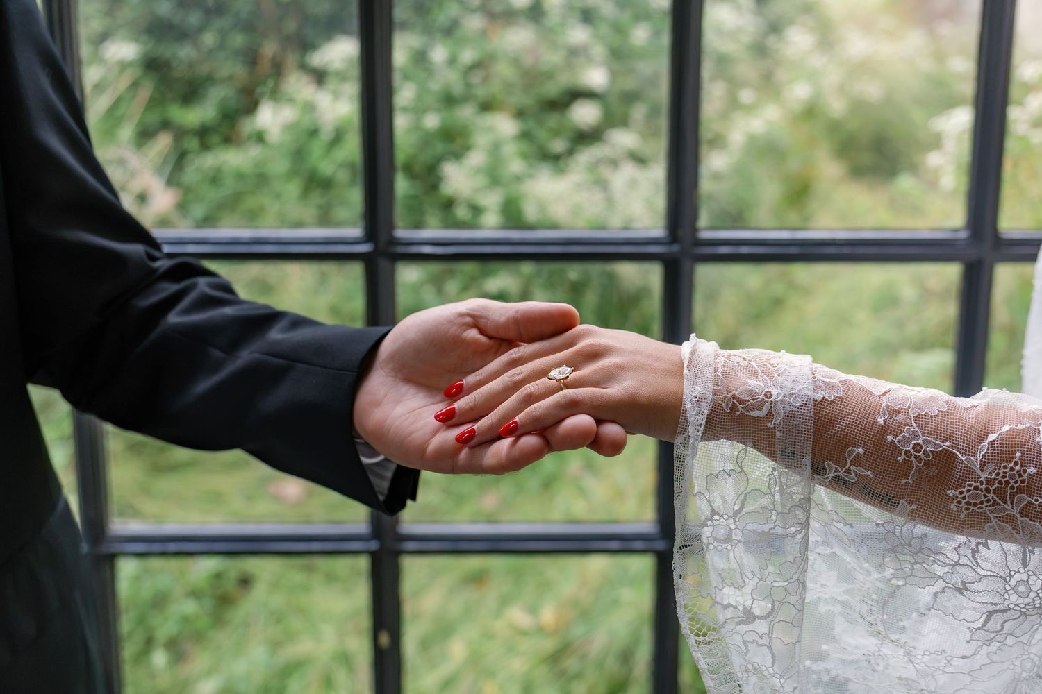Close-up of an engaged couple holding hands at Conestoga House and Gardens during their engagement session in Lancaster, Pennsylvania.
