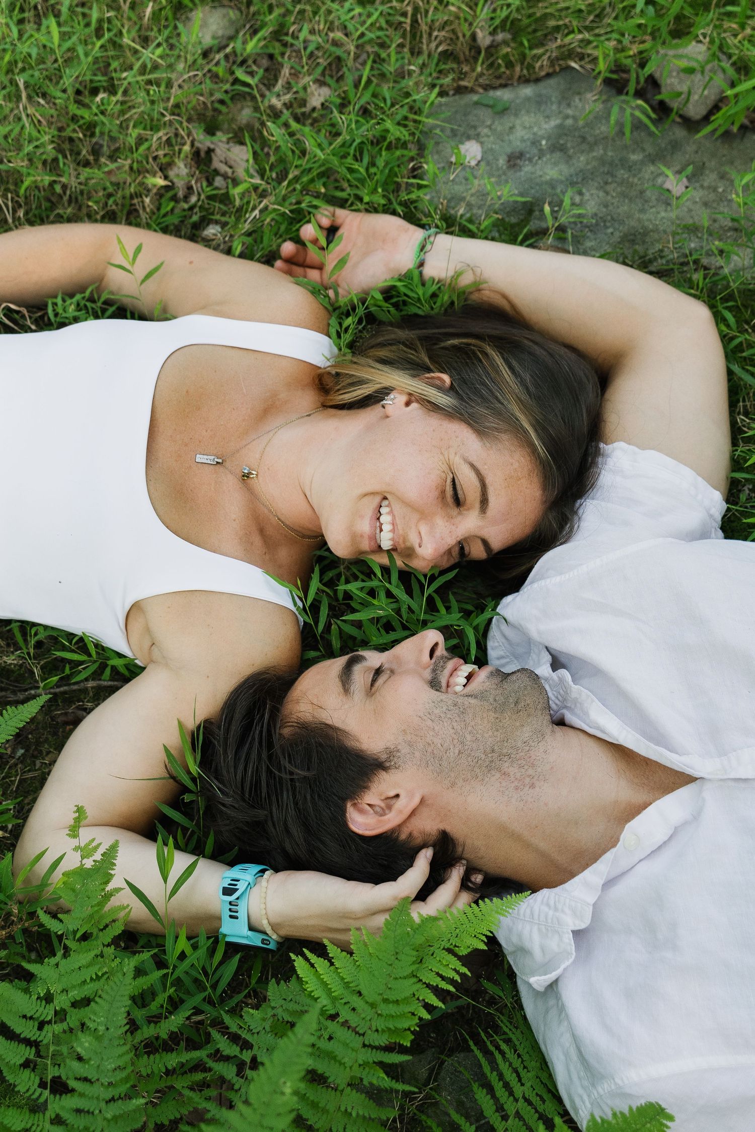 Couple lying together in the grass during a relaxed outdoor couples photography session in Pennsylvania