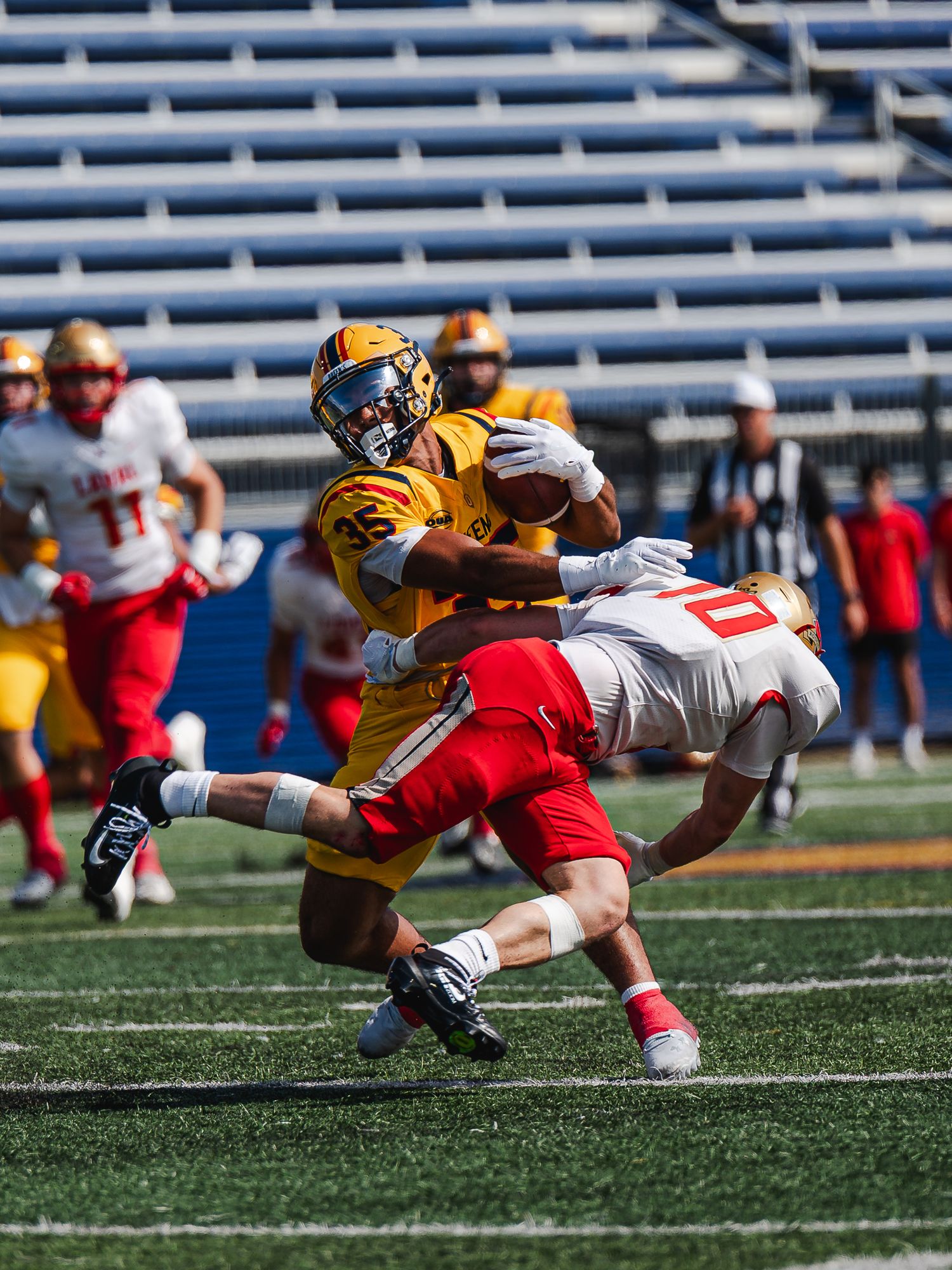 Queen's football player breaks tackle attempt by Laval defender.