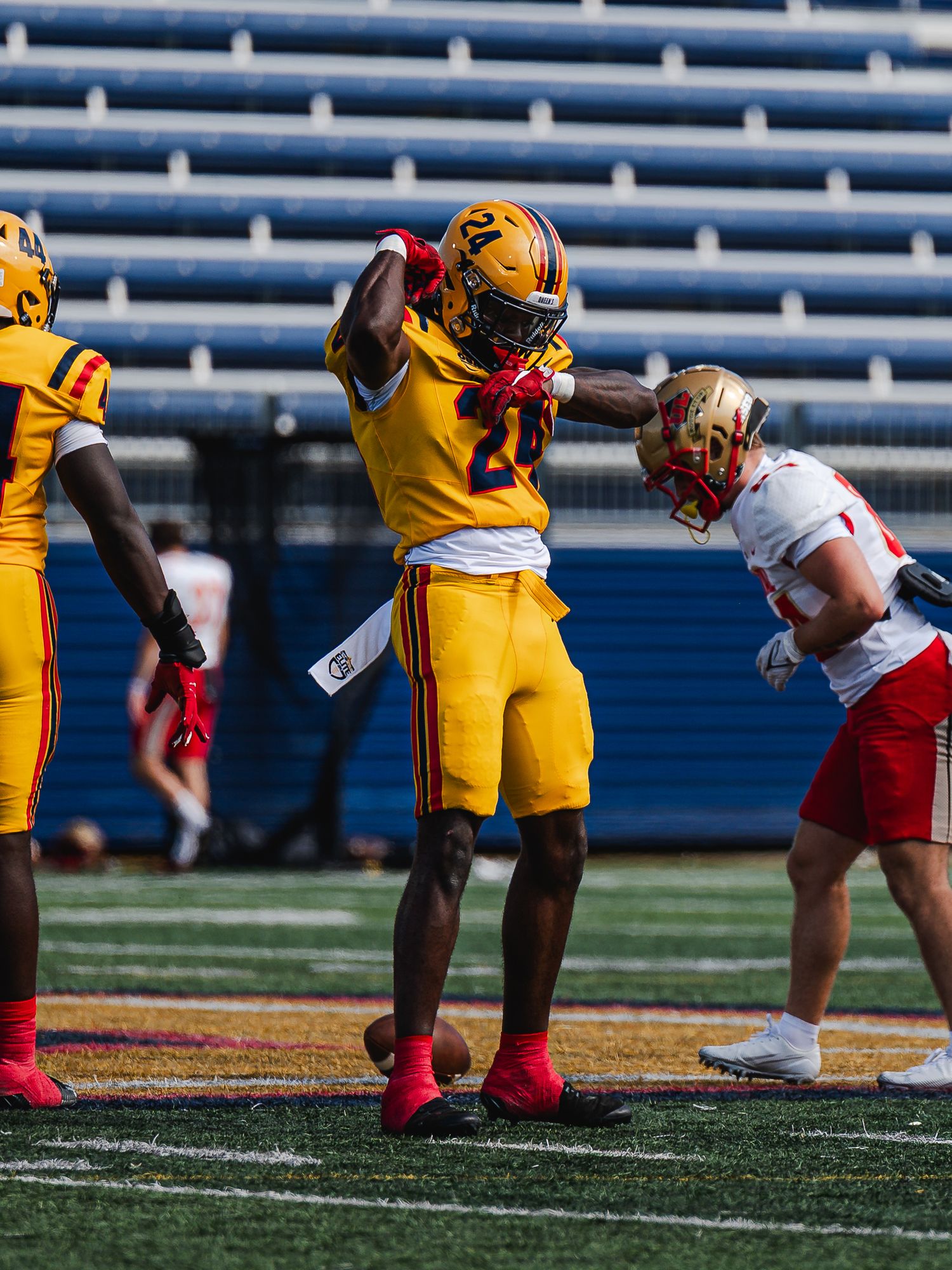 Queen's University football player celebrates after successful play.