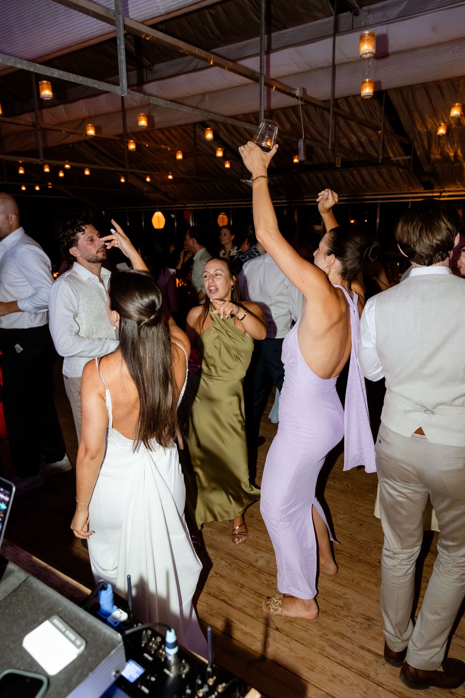 Guests celebrating on the dance floor at a lively wedding reception party.