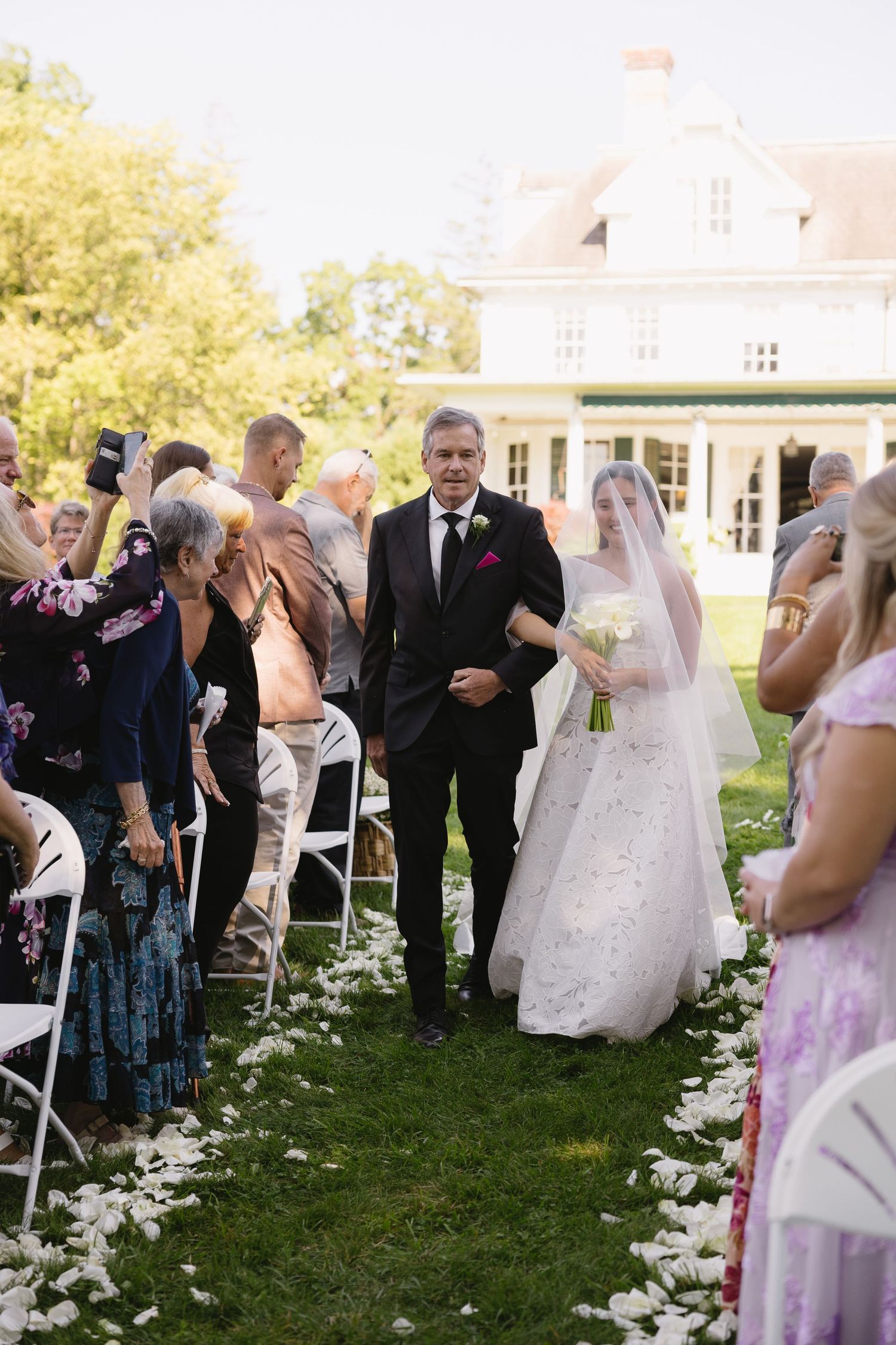 Bride walking down the outdoor aisle with her father at Wadsworth Homestead in Geneseo, NY.