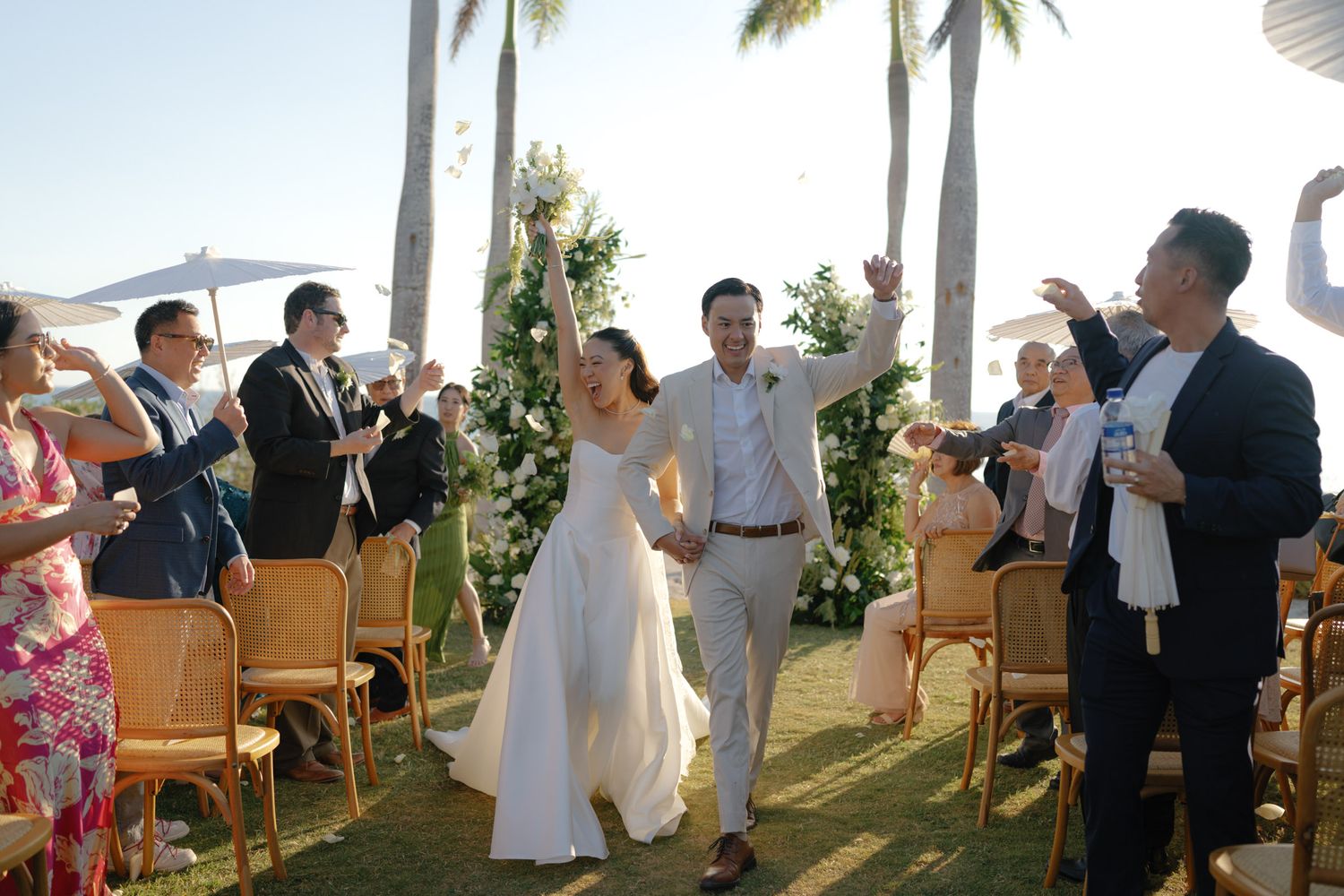 Joyful bride and groom walk celebration during their wedding ceremony in costa rica