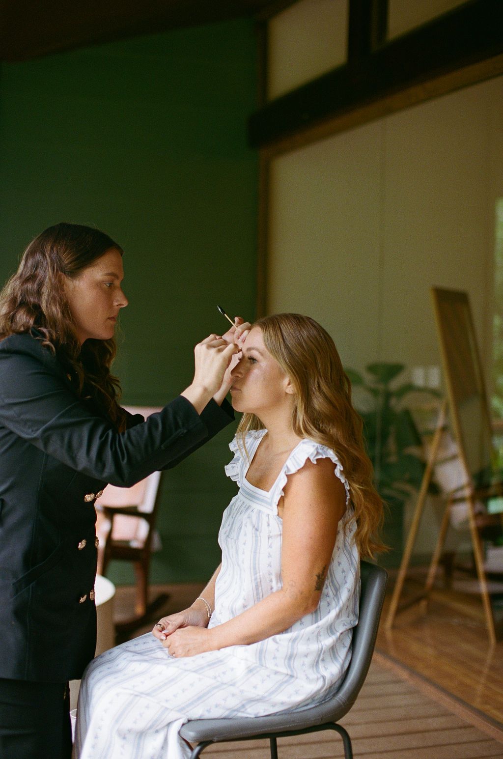 Bride having her makeup done while getting ready for a rainforest wedding in Costa Rica