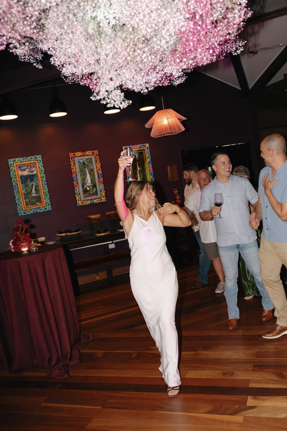 A bride-to-be in a white dress celebrating during the welcome party