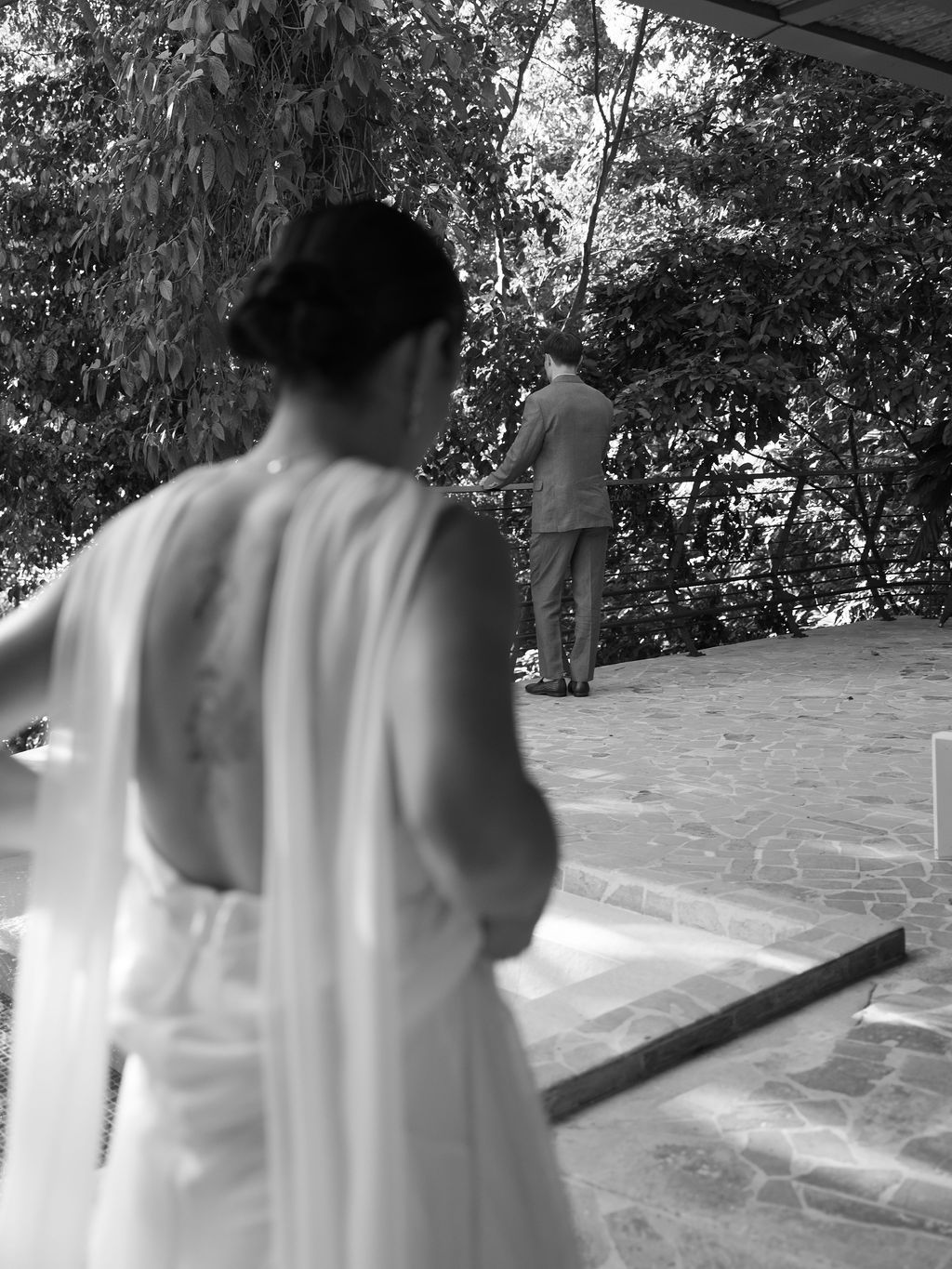Bride approaching the groom for their first look surrounded by rainforest at Villa Punto de Vista.