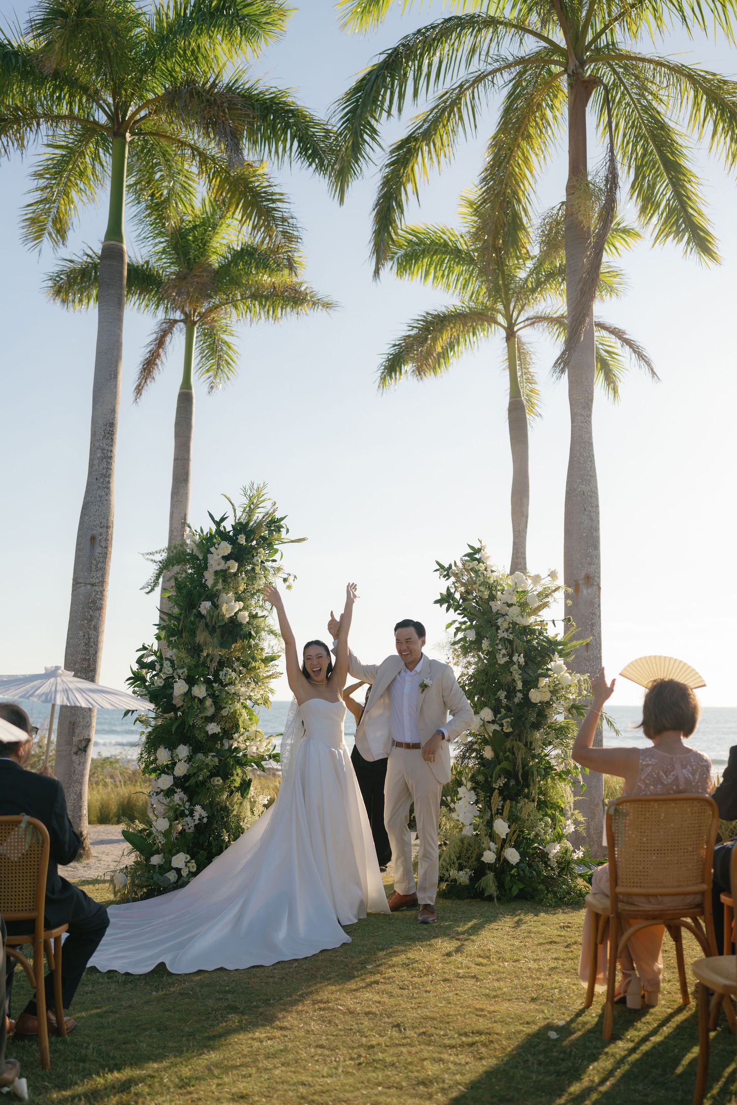 Ashley and Ryan celebrating after their beach wedding ceremony at Hacienda Pinilla in Costa Rica