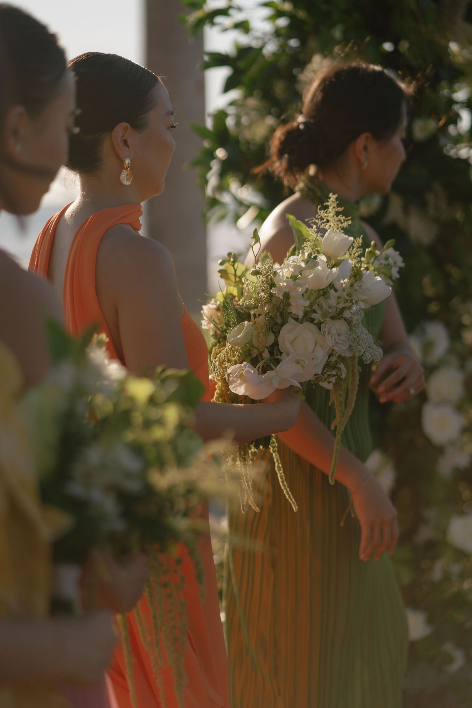 Bridesmaid holding a white and green floral bouquet during a wedding in Guanacaste, Costa Rica