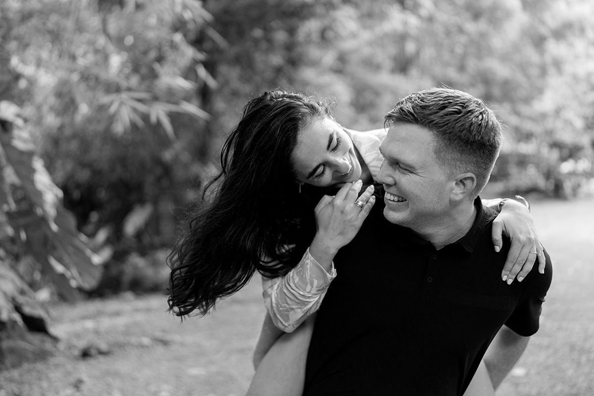 Black and white photo of a laughing couple embracing outdoors in costa rica