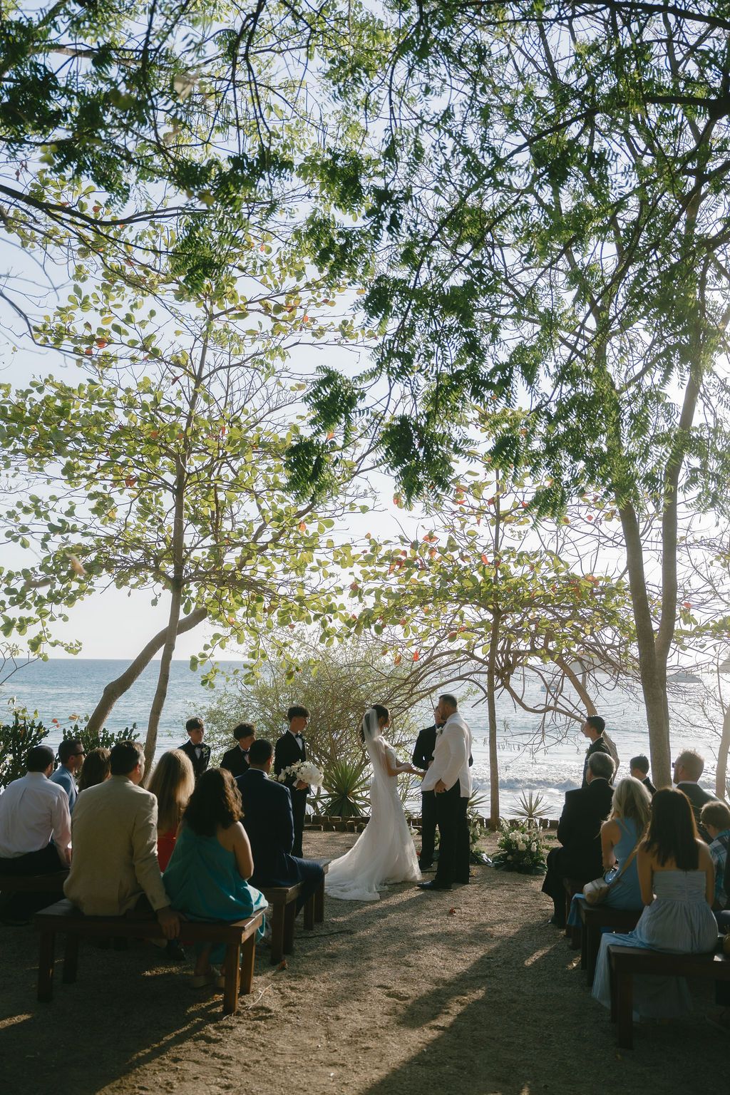 Bride and groom exchange vows during an outdoor beachside wedding ceremony in Costa Rica